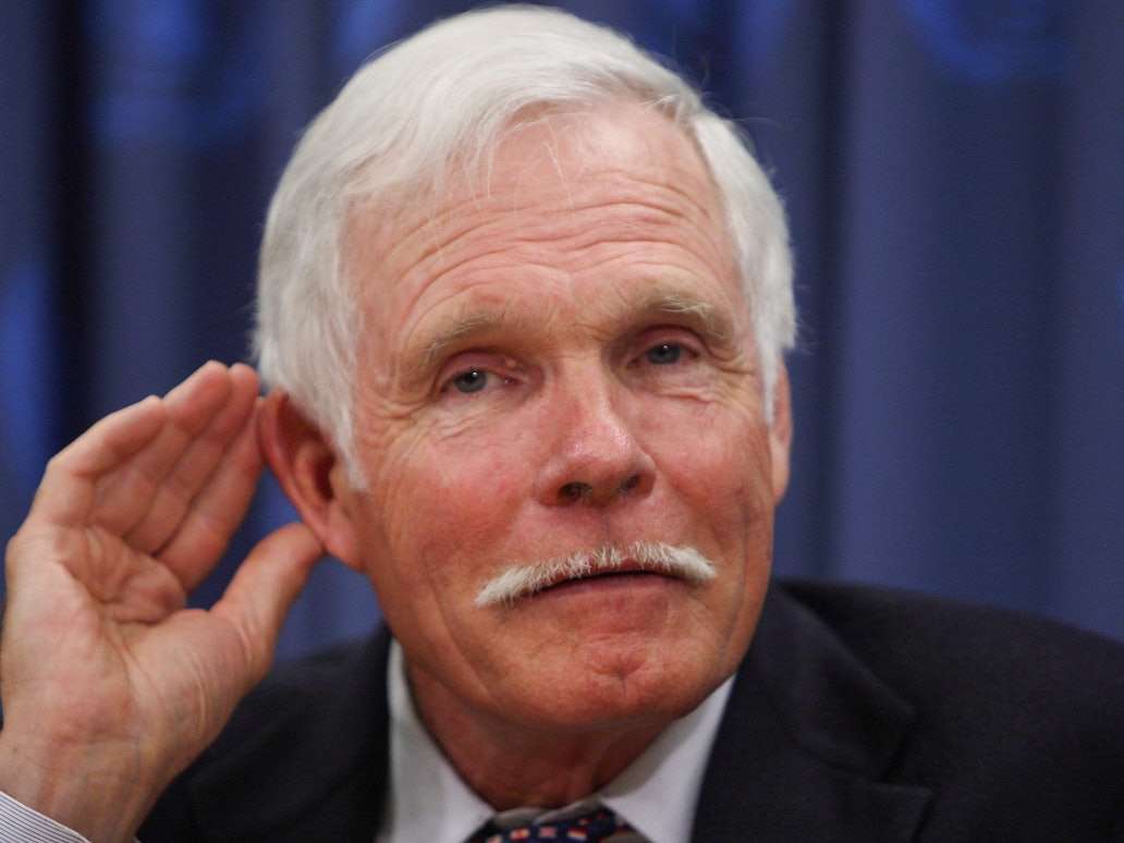 Ted Turner legt eine Hand ans Ohr.