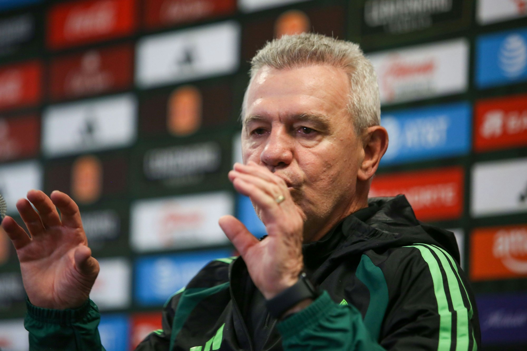 Javier Aguirre gestikuliert bei einer Pressekonferenz.
