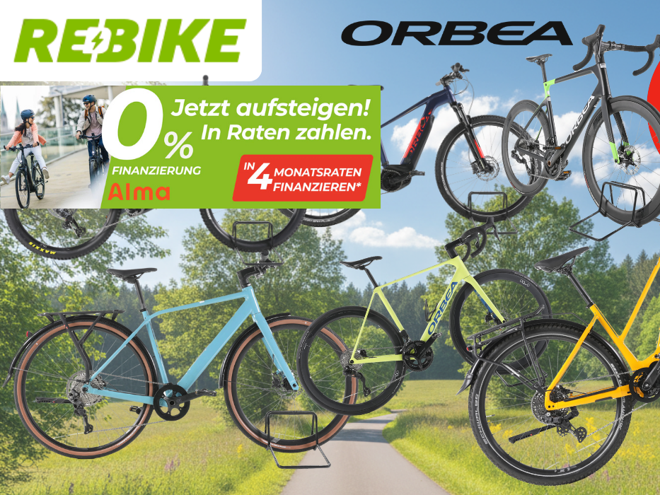 Mehrere refurbished Orbea E-Bikes verschiedener Kategorien – darunter E-Mountainbikes, Trekking-E-Bikes und Gravelbikes – vor einem sonnigen Radweg mit grüner Natur im Hintergrund. Logos von Rebike und Orbea sind zu sehen.