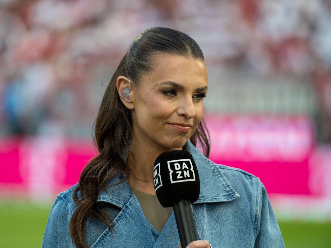 Laura Wontorra hält ein DAZN-Mikrofon in der Hand.