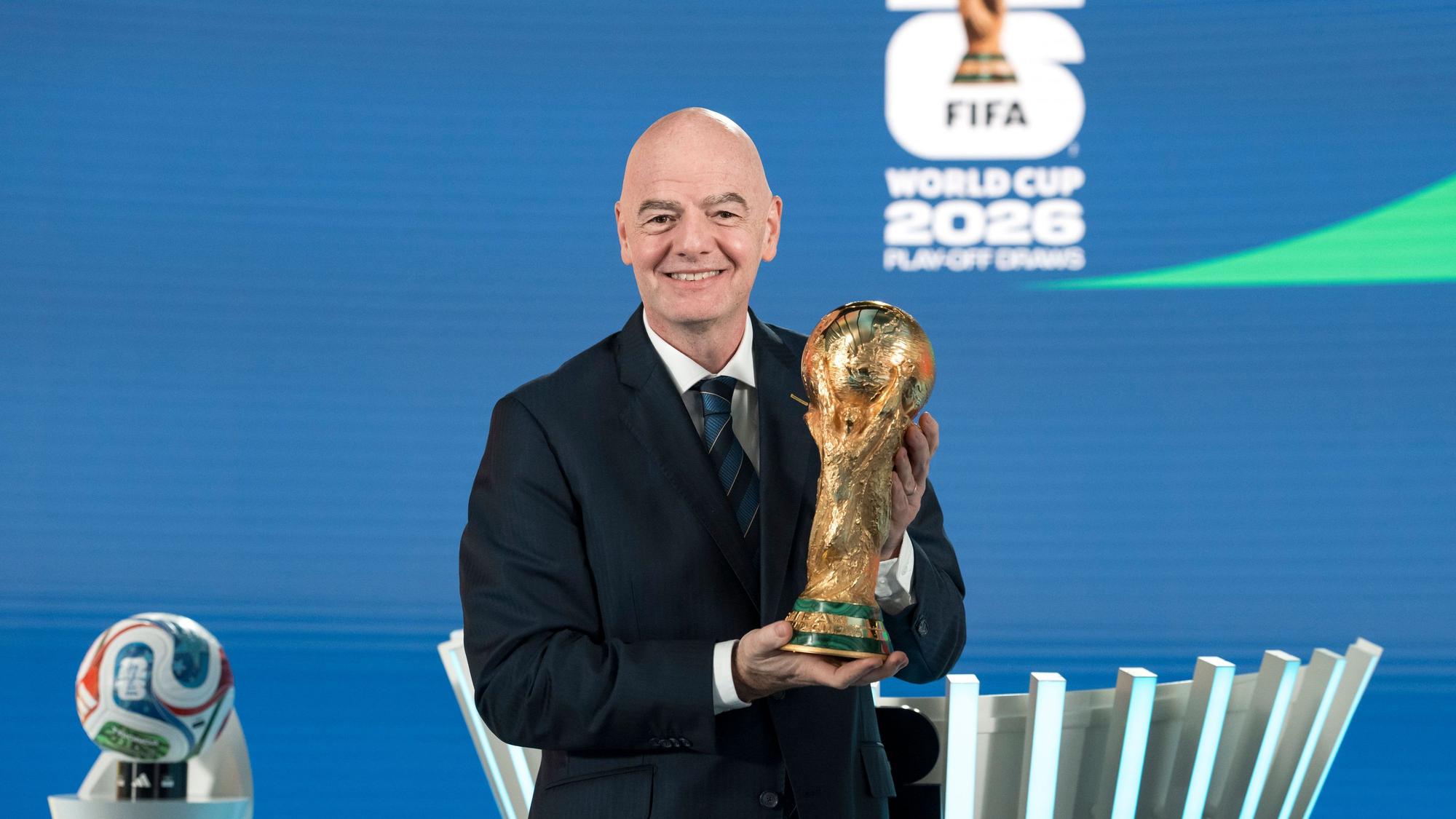 Gianni Infantino, FIFA-Präsident, hält während der Auslosung der Playoffs für die FIFA‑Fußball-Weltmeisterschaft 2026 den WM-Pokal.