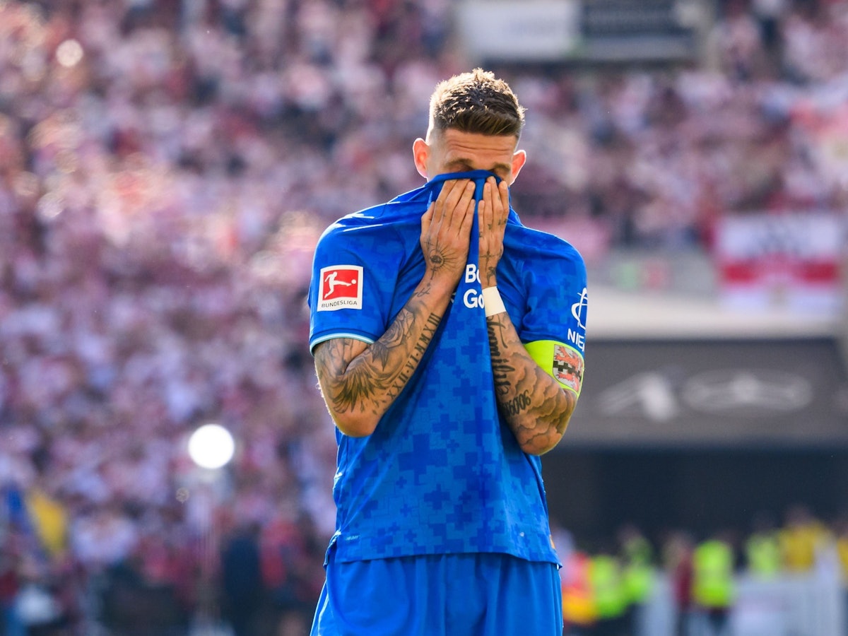 Robert Andrich vergräbt sein Gesicht im Trikot.