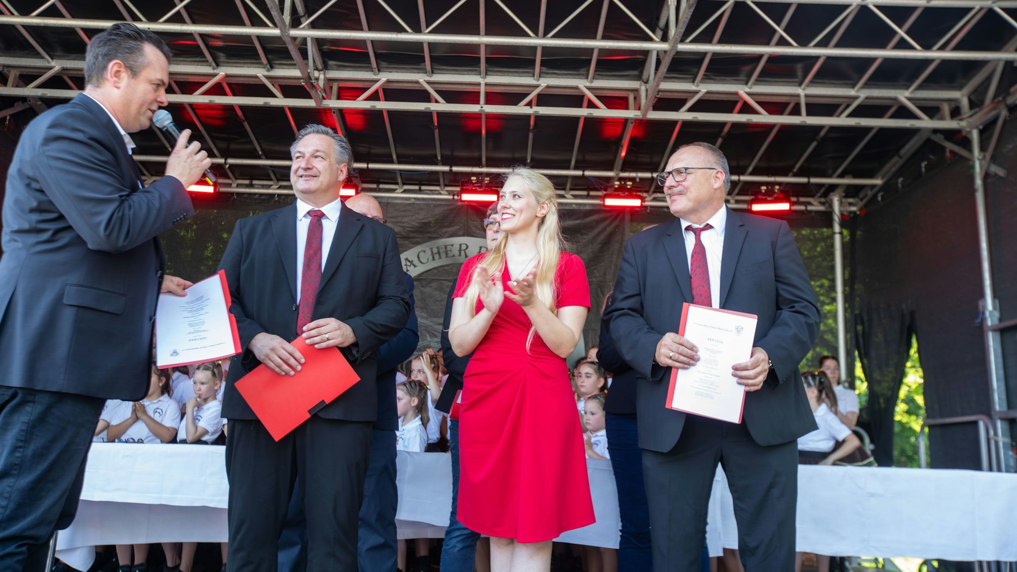 Holger Harms (l.), Präsident des Festausschusses Porzer Karneval (FAS) überreicht dem designierten Porzer Dreigestirn um Jörg Weingärtner, Jacqueline Jacobs-Bäuml und Stefan Lohe (v.l.) die Verträge.