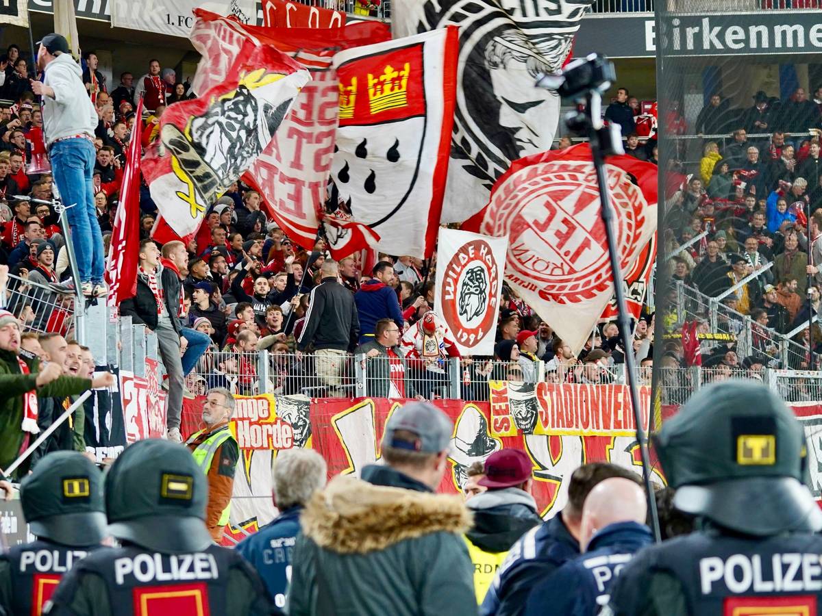 Die Fans des 1. FC Köln beim Spiel gegen den SC Freiburg. Am Zaun hängt ein Banner mit der Aufschrift „Stadionverbot“.