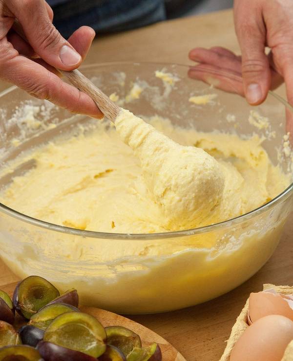 Eine Frau vermengt Zutaten für einen Rührteig