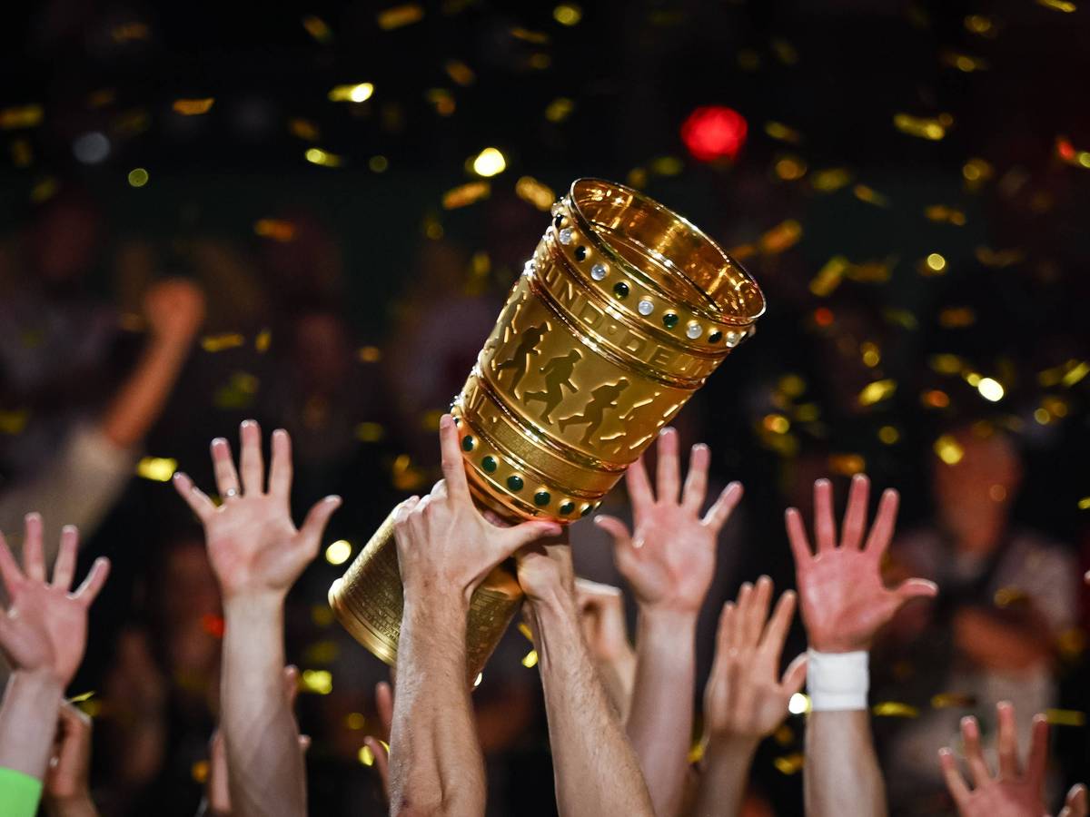 Hände von Spielern recken den DFB-Pokal in die Höhe.