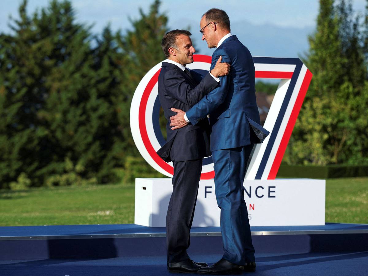 Frankreichs Präsident Emmanuel Macron (l.) begrüßt Bundeskanzler Friedrich Merz beim G7-Gipfel.