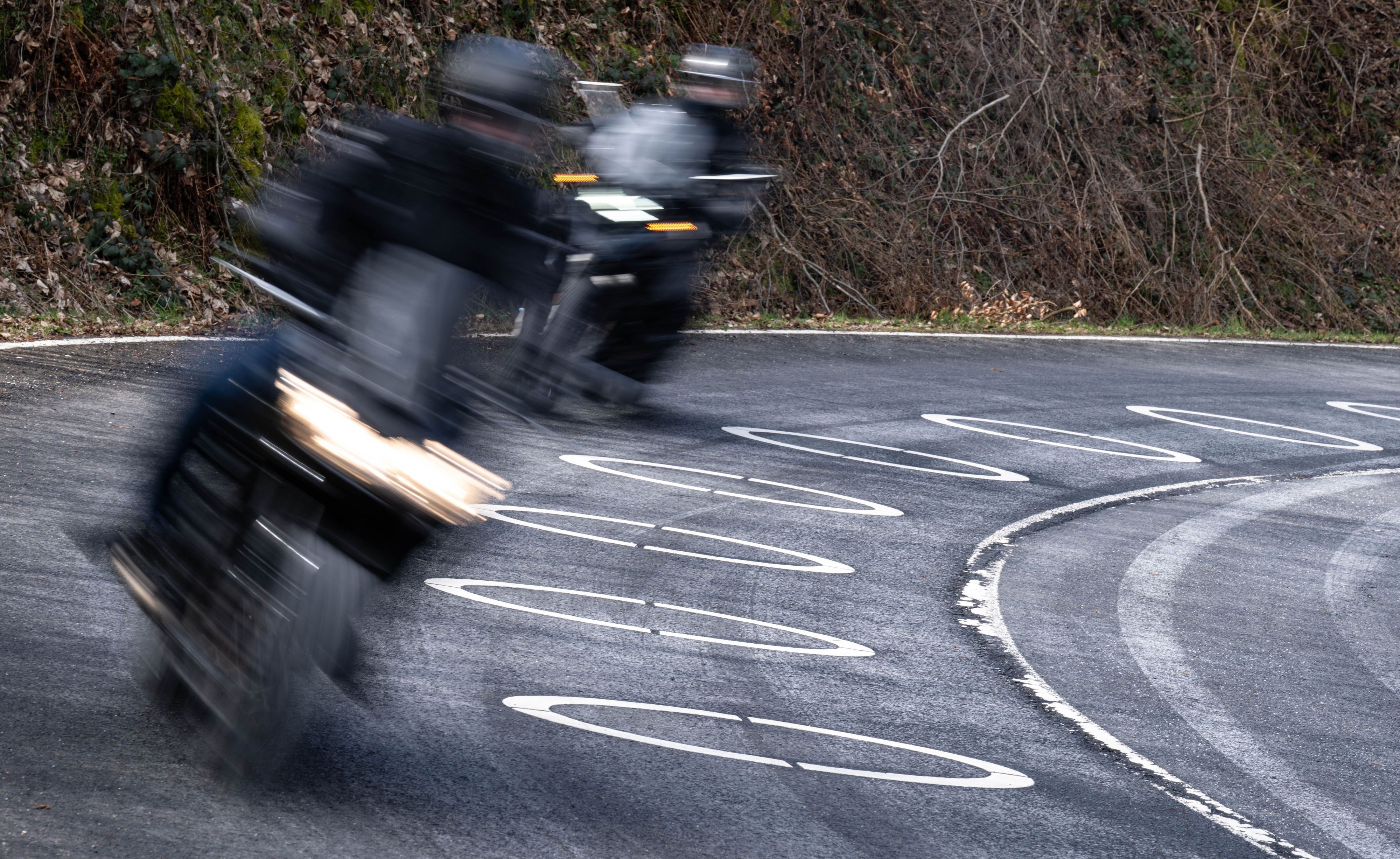Motorradfahrer durchfahren die mit Ellipsen markierte Kurve des Verkehrsversuches bei der Eröffnung der Motorradsaison.