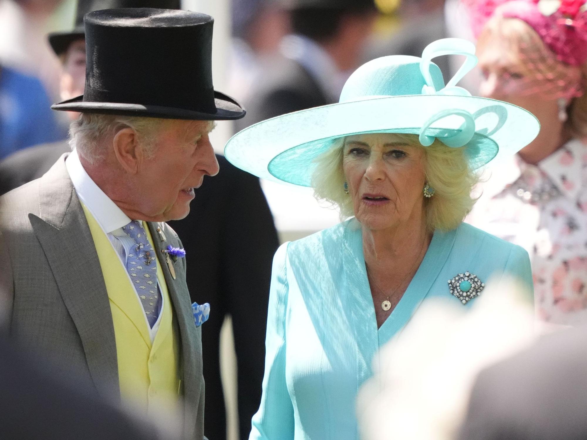 König Charles III. (l) und Königin Camilla fahren mit einer Kutsche am vierten Tag des Ascot Pferderennens an der Rennstrecke vor.