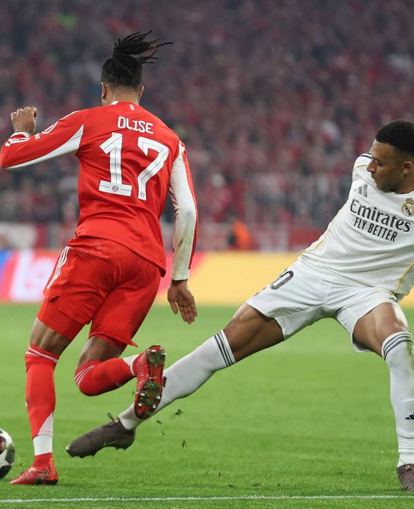 Michael Olise vom FC Bayern dribbelt an Real Madrids Kylian Mbappé vorbei.