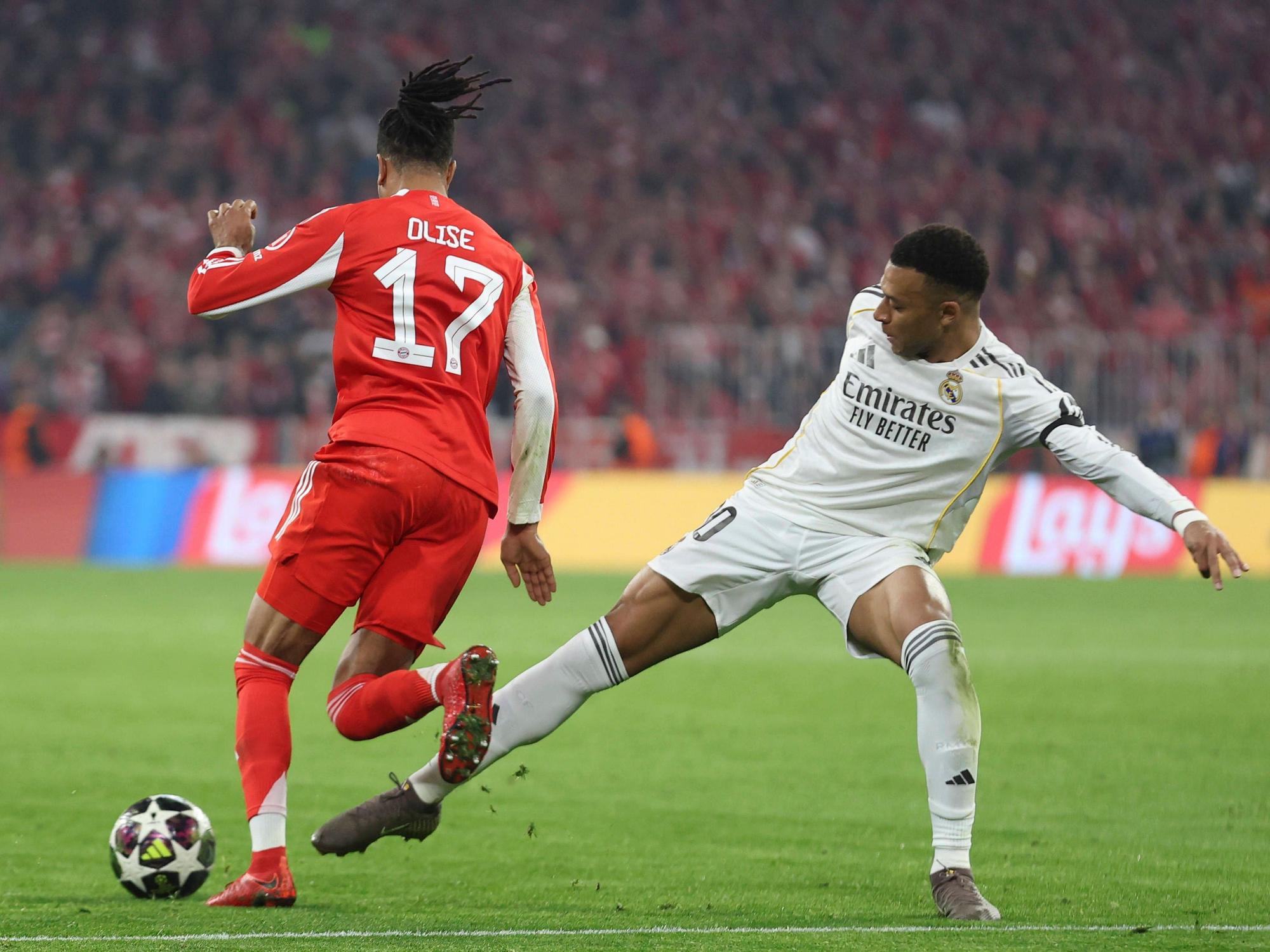 Michael Olise vom FC Bayern dribbelt an Real Madrids Kylian Mbappé vorbei.