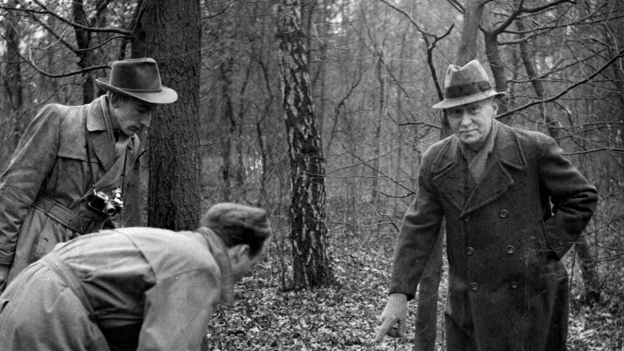 Der pensionierte Postbeamte Georg Binder (65) zeigt im Februar 1954 Journalisten in einem Wald am Stadtrand von Köln, wo er die Leiche von Ronald Chesney gefunden hatte, nachdem dieser sich durch einen Schuss das Leben genommen hatte.