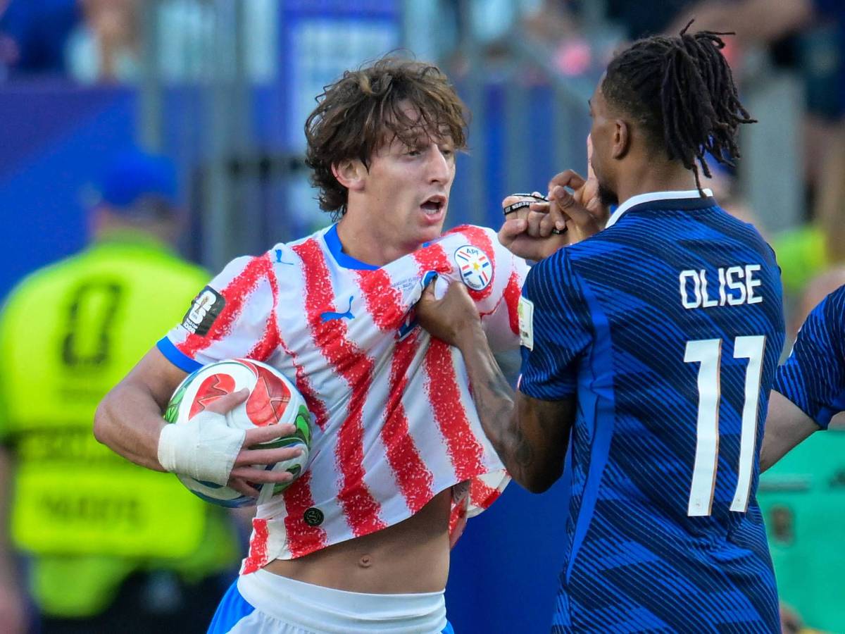 Michael Olise zeigt Matías Galarza mit dem Zeigefinger auf dem Mund an, still zu sein.