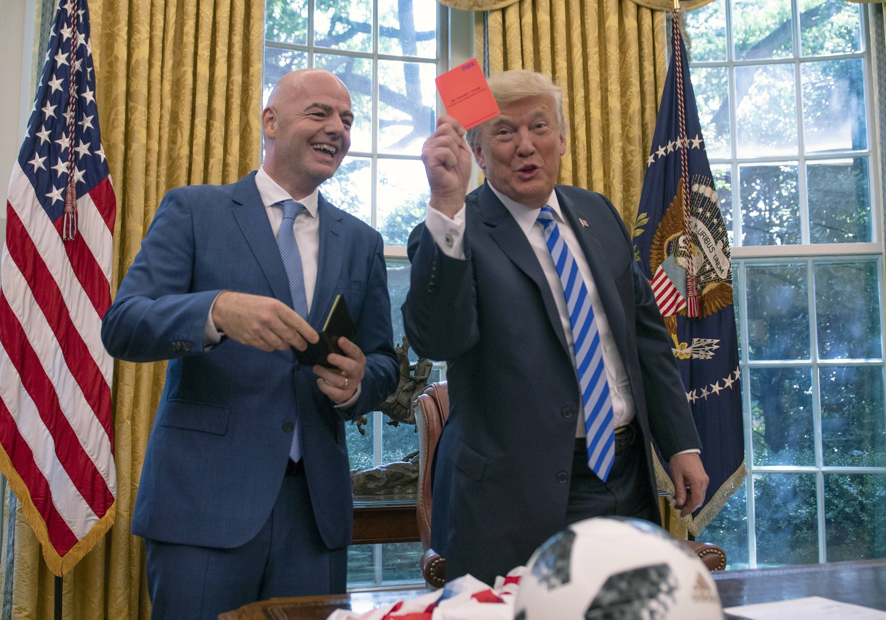 US-Präsident Donald Trump hält im Oval Office eine Rote Karte in die Kamera, FIFA-Präsident Gianni Infantino lacht.