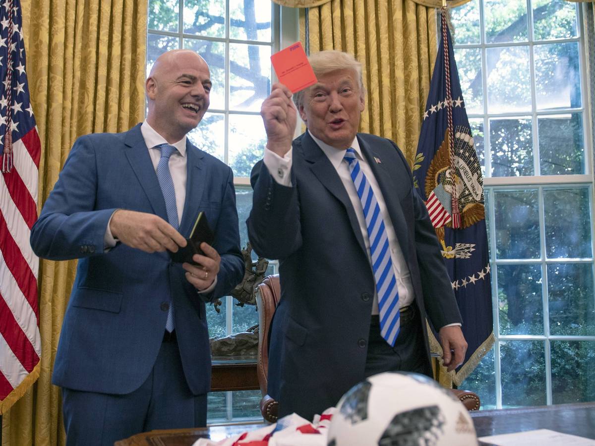 US-Präsident Donald Trump hält im Oval Office eine Rote Karte in die Kamera, FIFA-Präsident Gianni Infantino lacht.