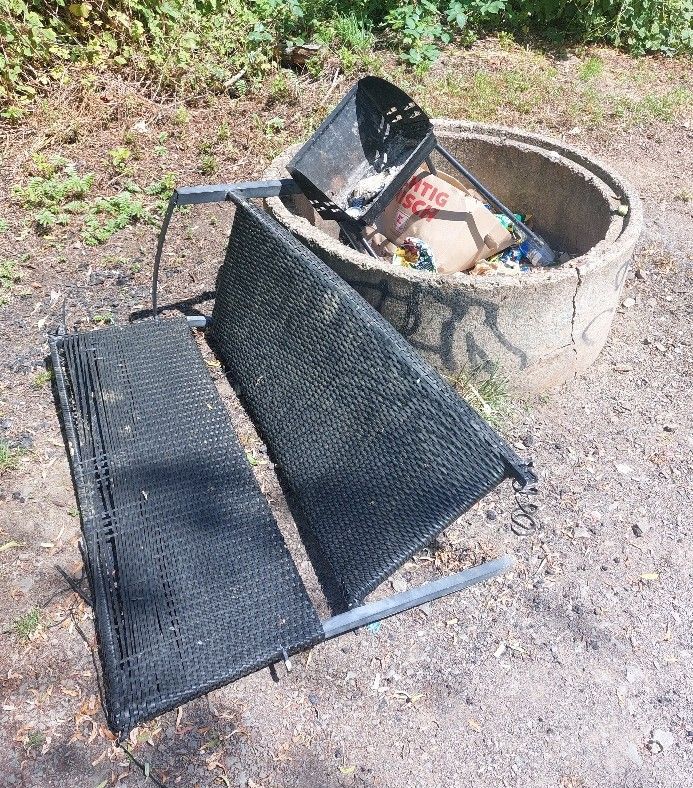 Eine kaputte Sitzbank und ein alter Grill wurden hier achtlos entsorgt.