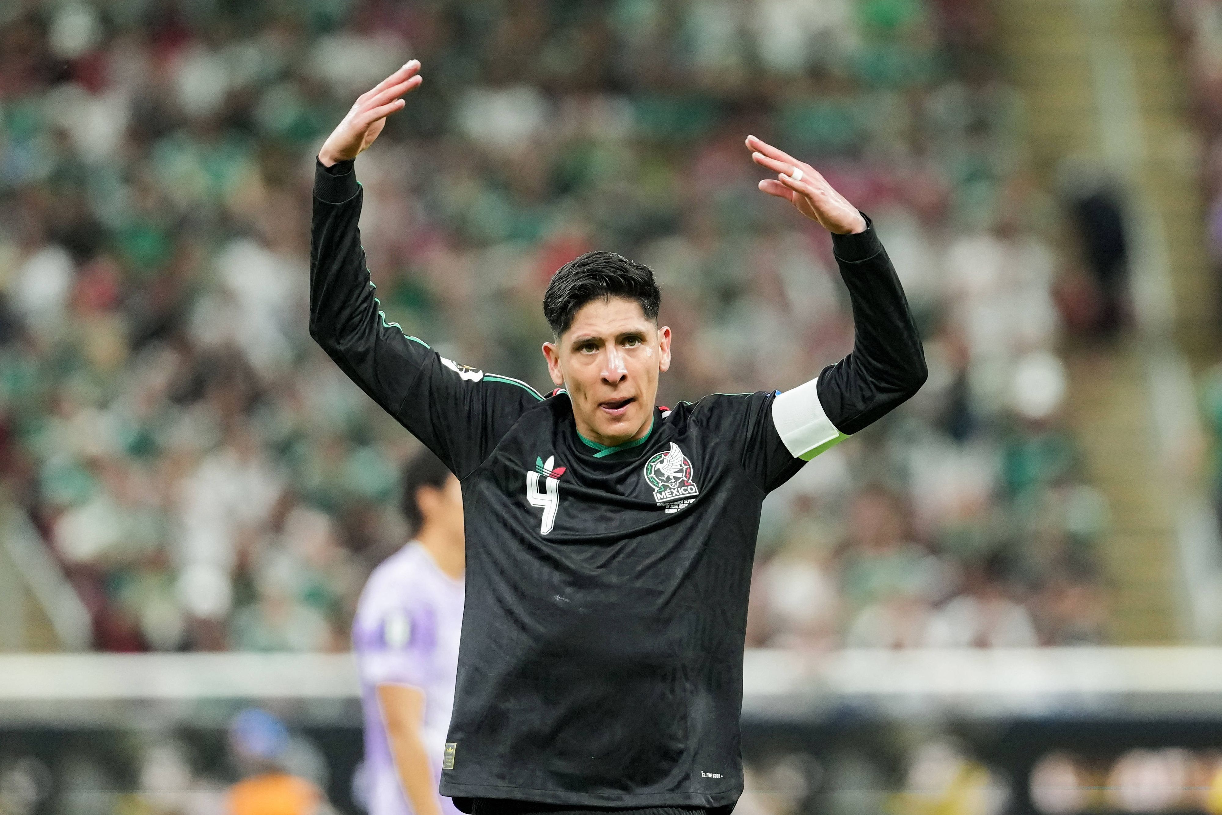 Edson Álvarez hebt die Arme.