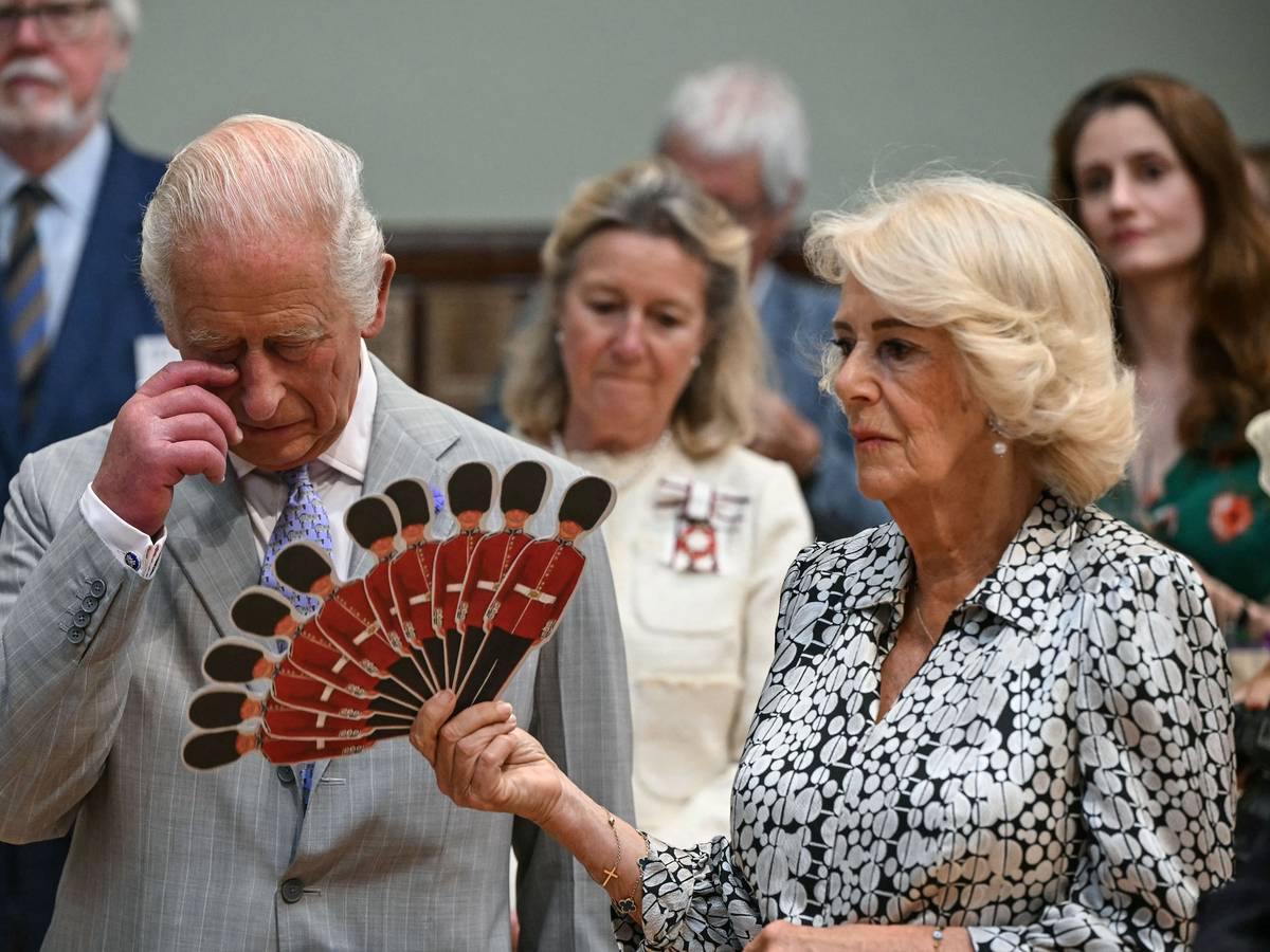 Königin Camilla fächelt König Charles III. Luft zu, während sie einer Aufführung der Dorset Opera lauschen.