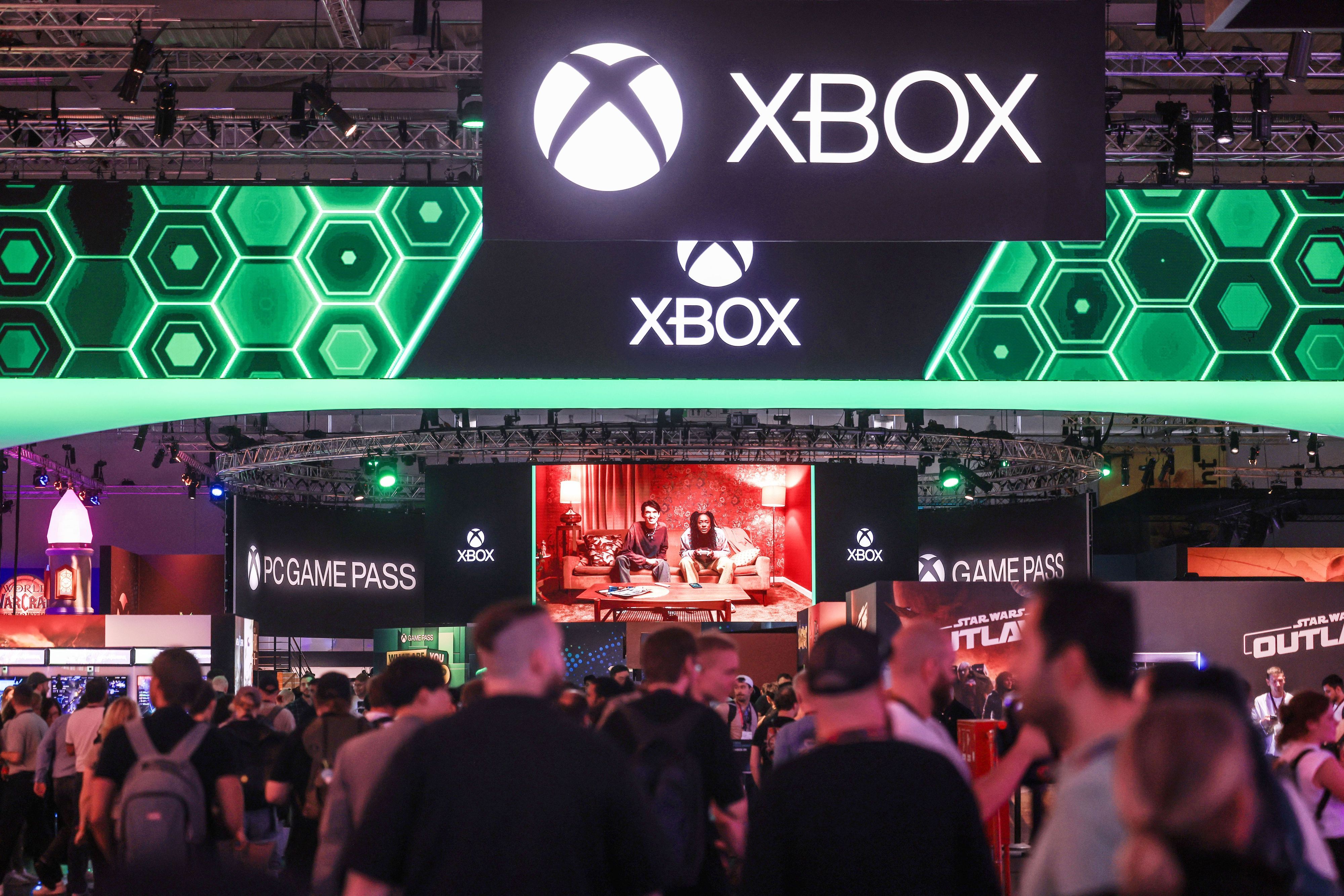 Besucher der Computer- und Videospielmesse Gamescom gehen zum Stand von Microsoft Xbox.