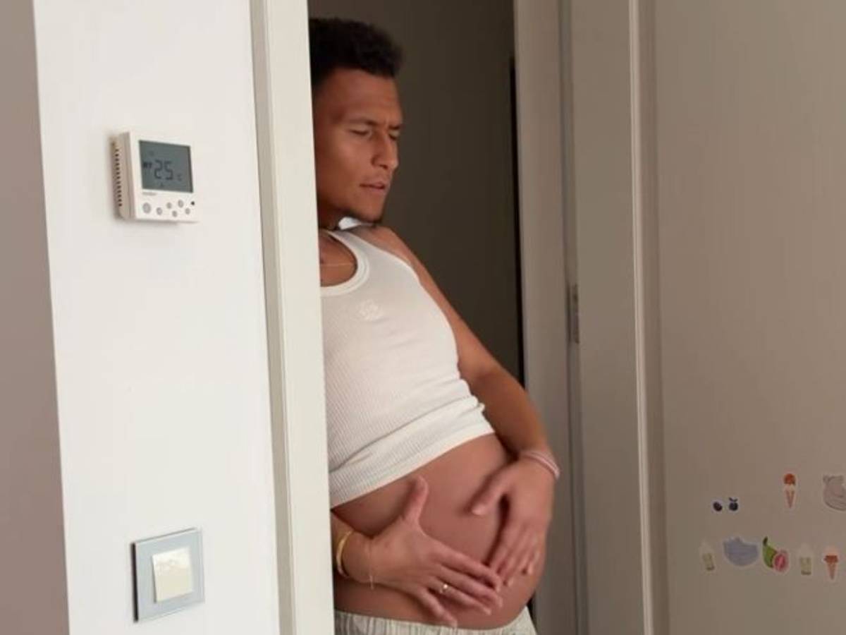 Davie Selke streichelt den Babybauch seiner Frau, deren Kopf aber nicht zu sehen ist.