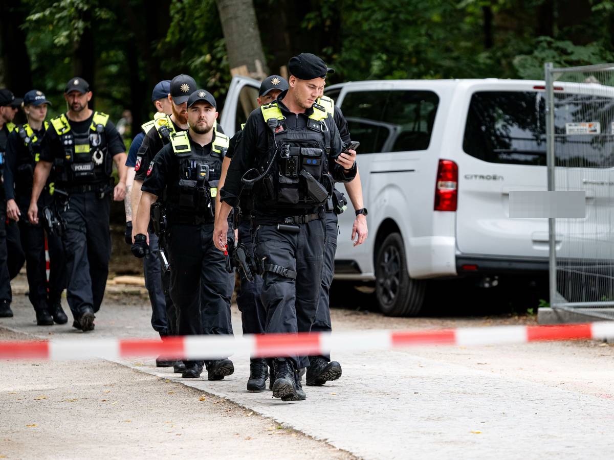 Polizisten laufen an dem Wagen vorbei, mit dem ein Mann am Rande des CSD in eine Menschenmenge fuhr.