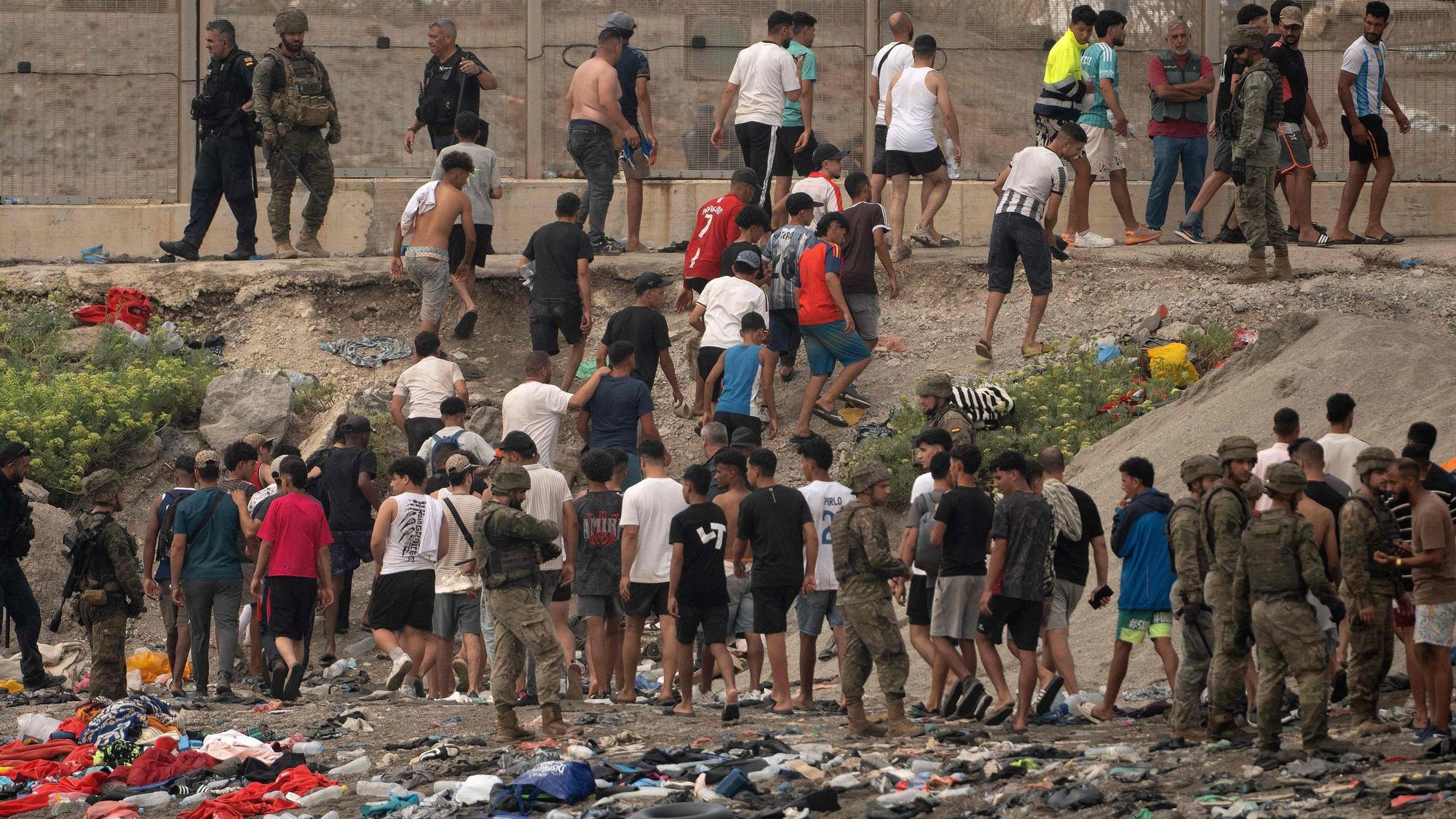 Spanische Soldaten überwachen Migranten, die nach Marokko zurückkehren, nachdem sie am 31. Juli 2026 die Grenze überquert hatten, um in die spanische Enklave Ceuta in Nordafrika einzureisen.