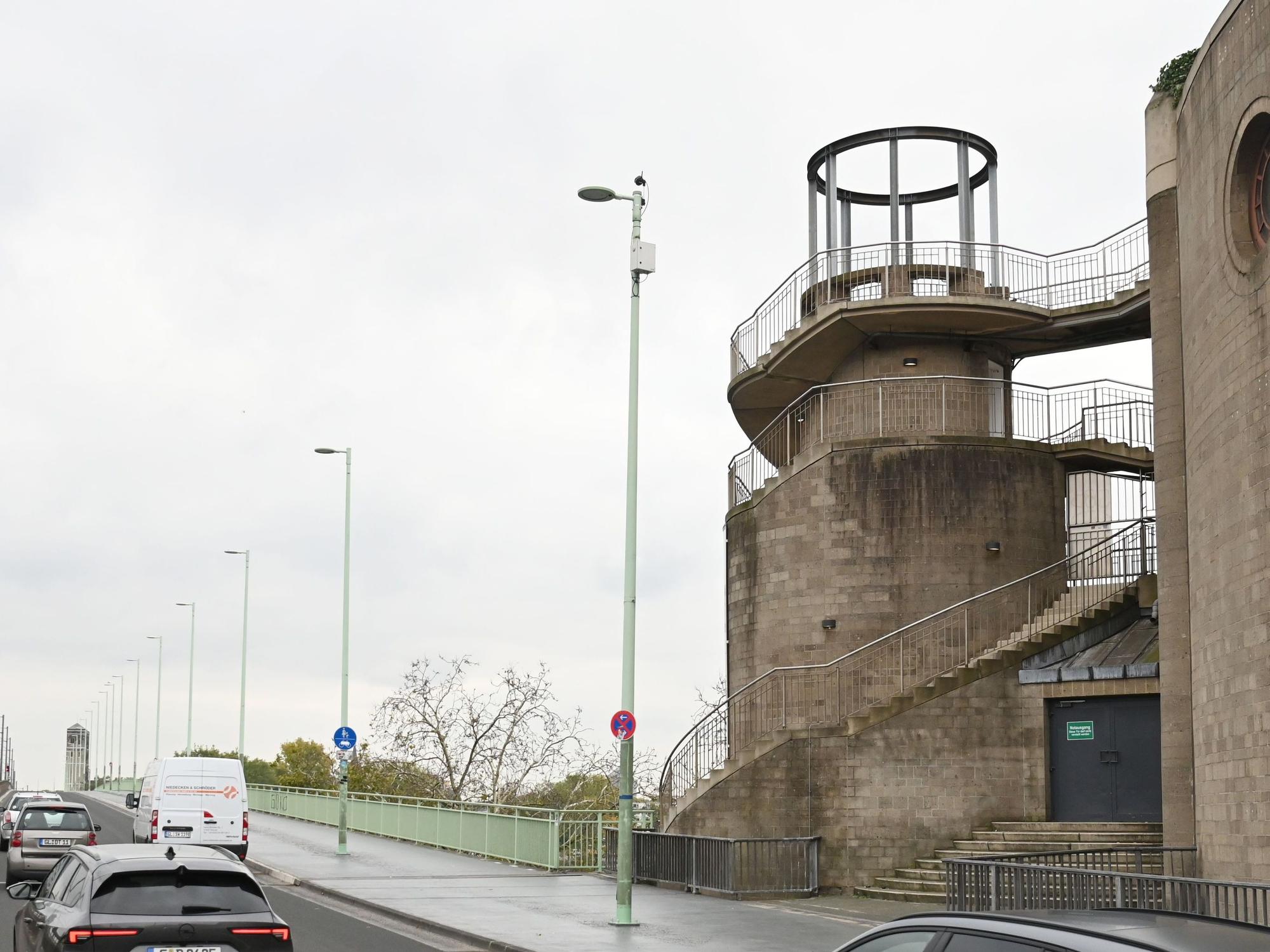 Ein Turm steht neben einer Brücke.