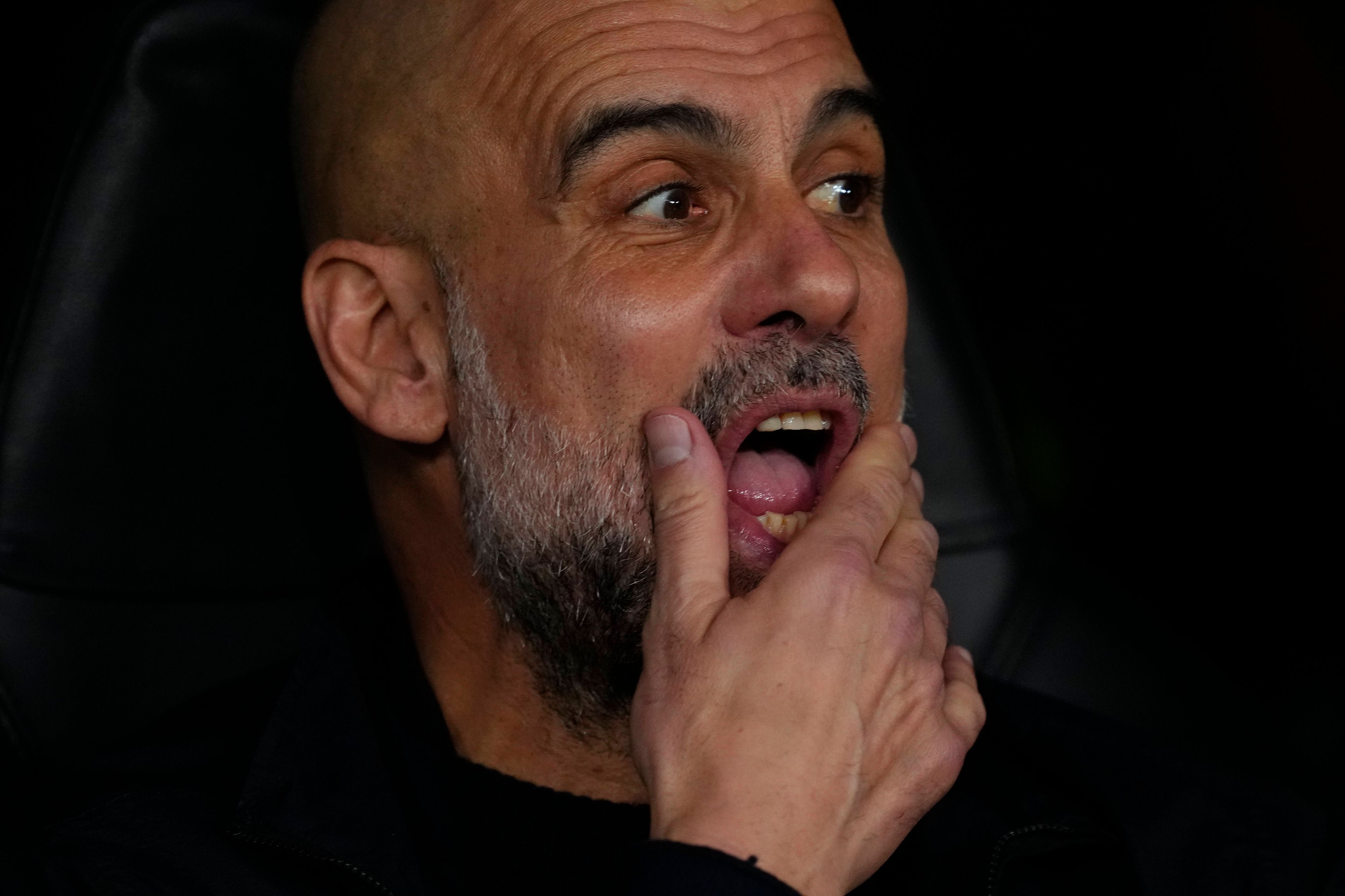Pep Guardiola schaut auf das Spielfeld und streicht sich durch den Bart.