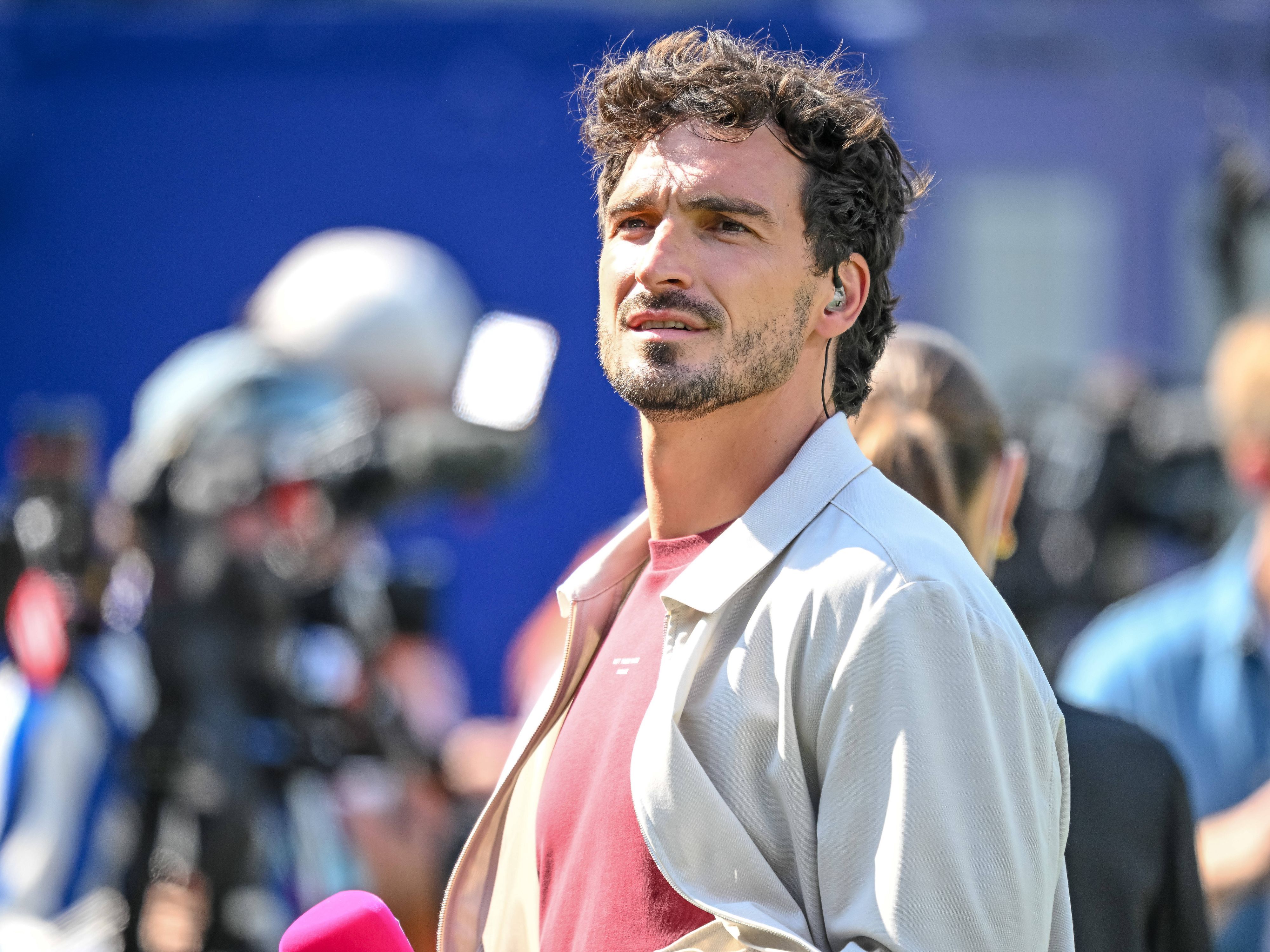 Mats Hummels steht mit Mikrofon am Spielfeldrand.
