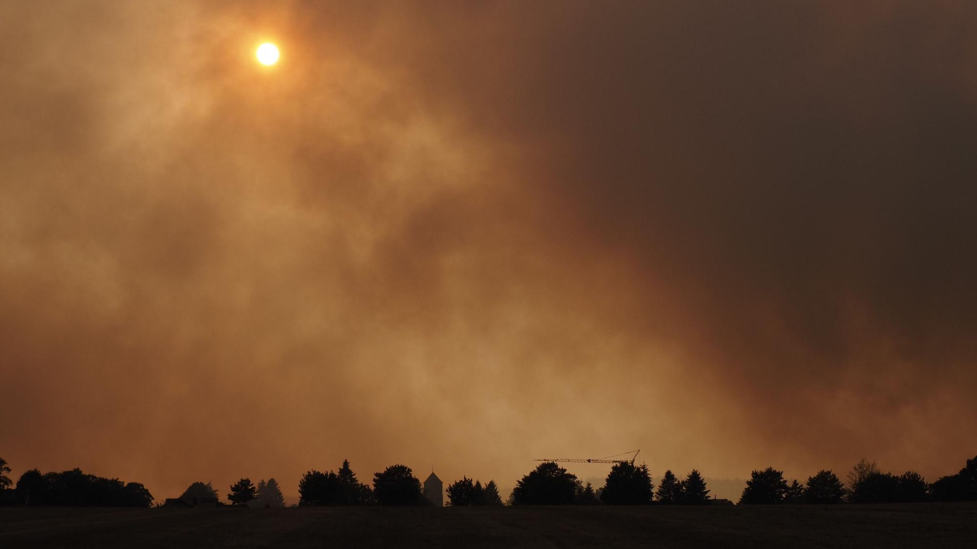 Der Rauch des Waldbrandes hängt in der Luft über dem Ortsteil Großhau in Hürtgenwald.
