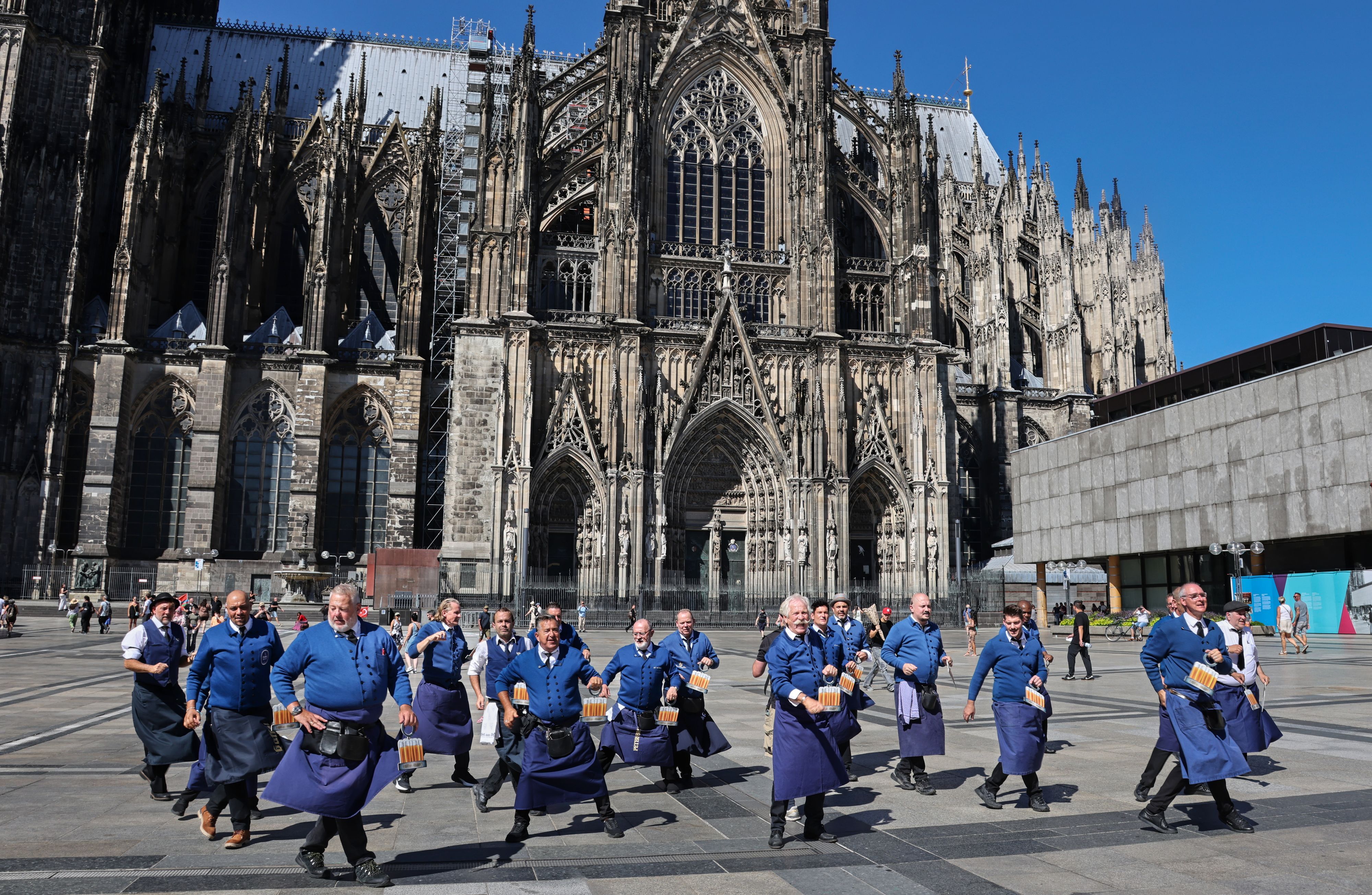 Die Köbesse tanzen mit Henning Krautmacher auf dem Roncalliplatz.