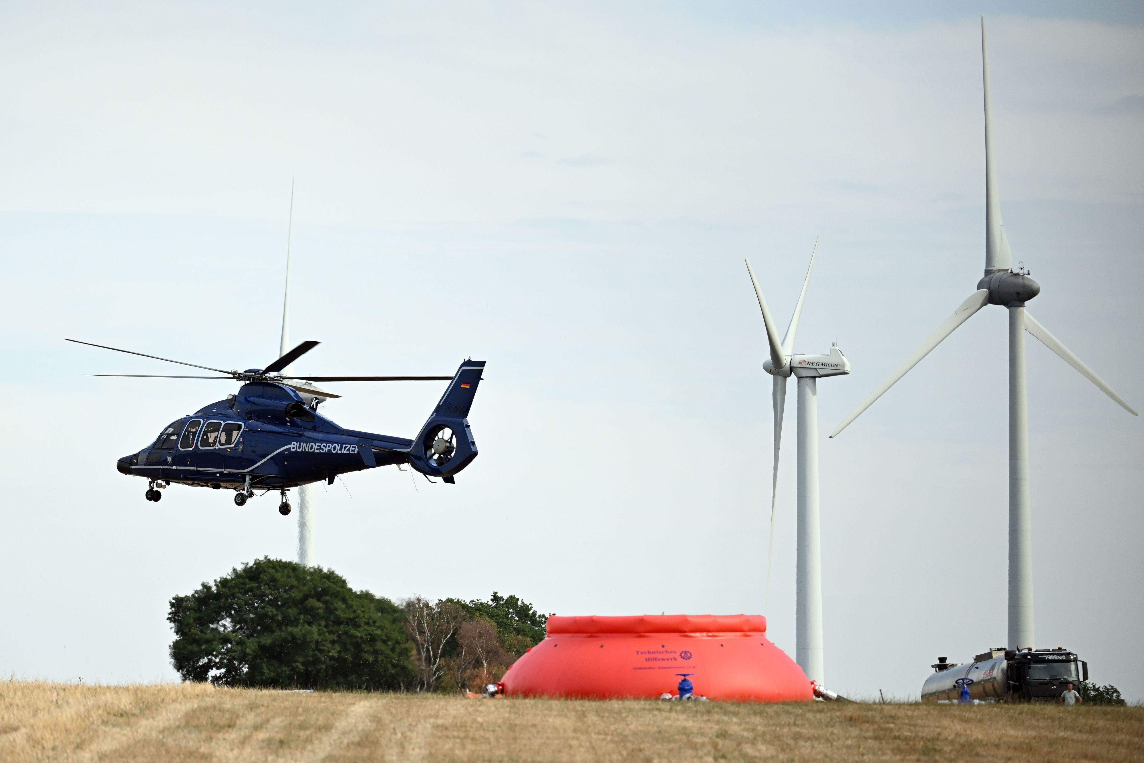 Ein Hubschrauber startet von einem improvisierten Feldflugplatz. Die Löschhubschrauber werden aktuell nicht mehr benötigt.