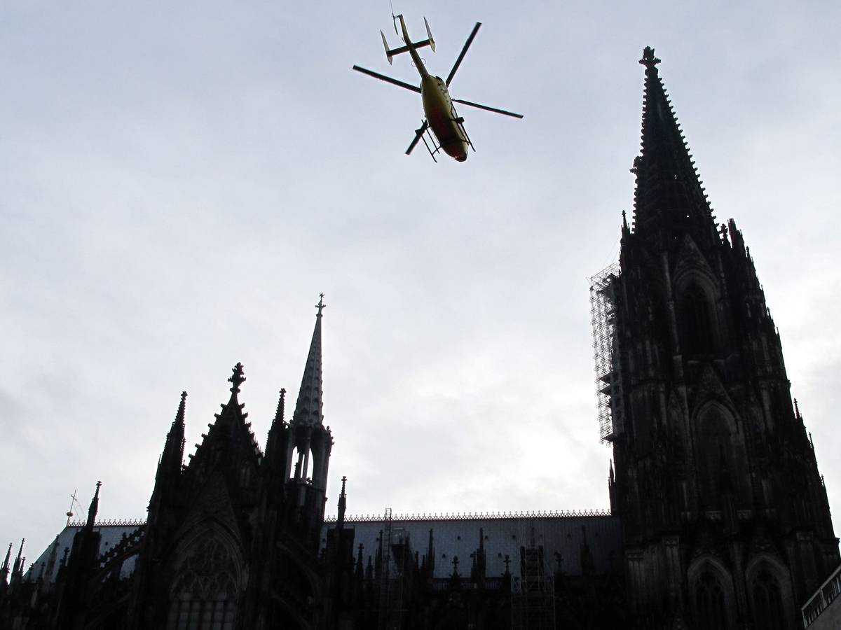 Ein ADAC-Rettungshubschrauber fliegt über den Dom in Köln hinweg. (Archivbild)