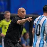 Hossam Hassan gestikuliert an der Seitenlinie. Im Vordergrund ist Lionel Messi unscharf zu sehen.