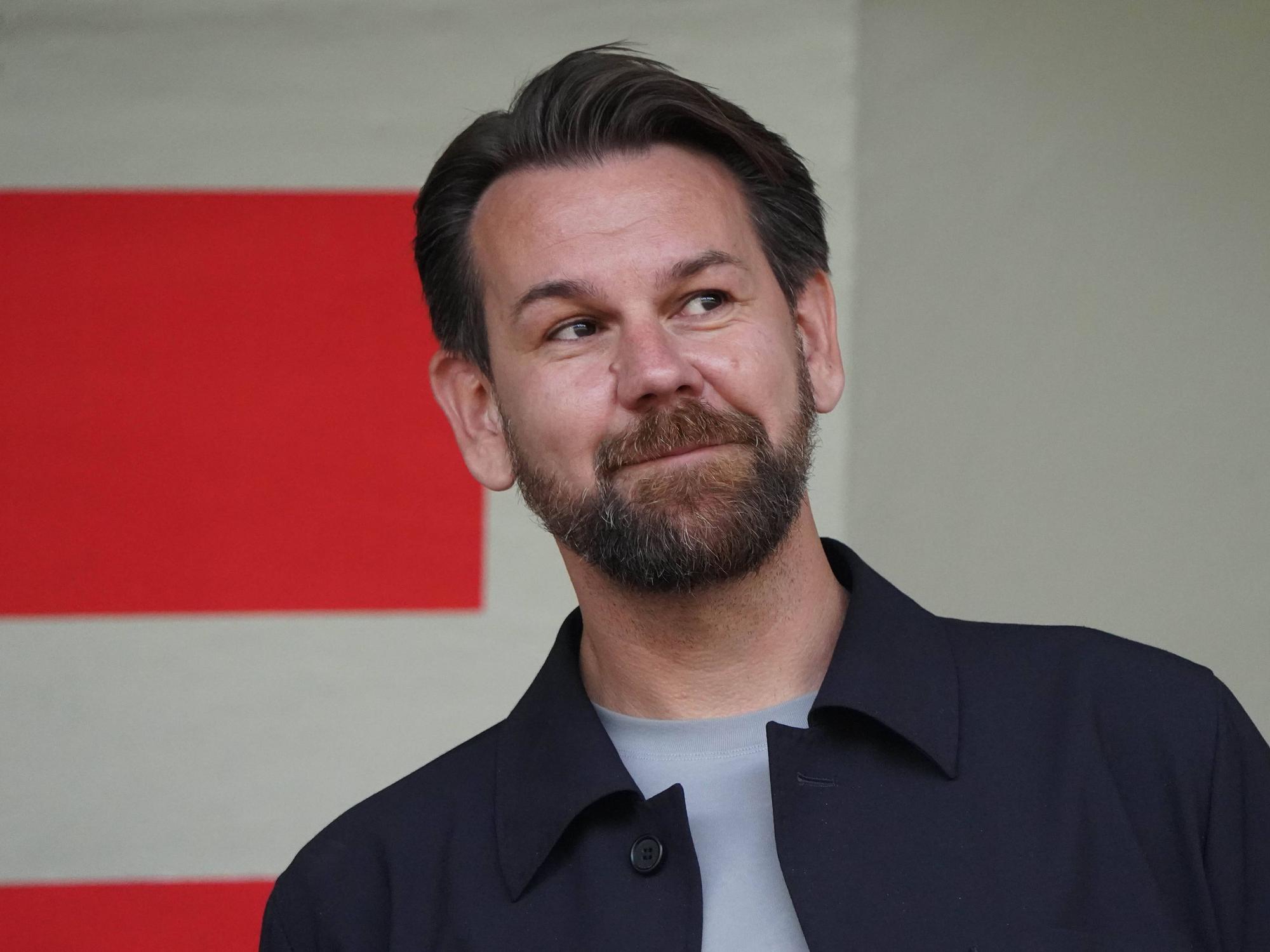 Thomas Kessler beobachtet lächelnd ein Testspiel.