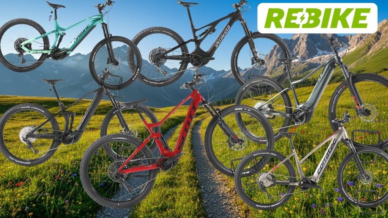 Mehrere refurbished E-Mountainbikes verschiedener Marken vor alpiner Bergkulisse.