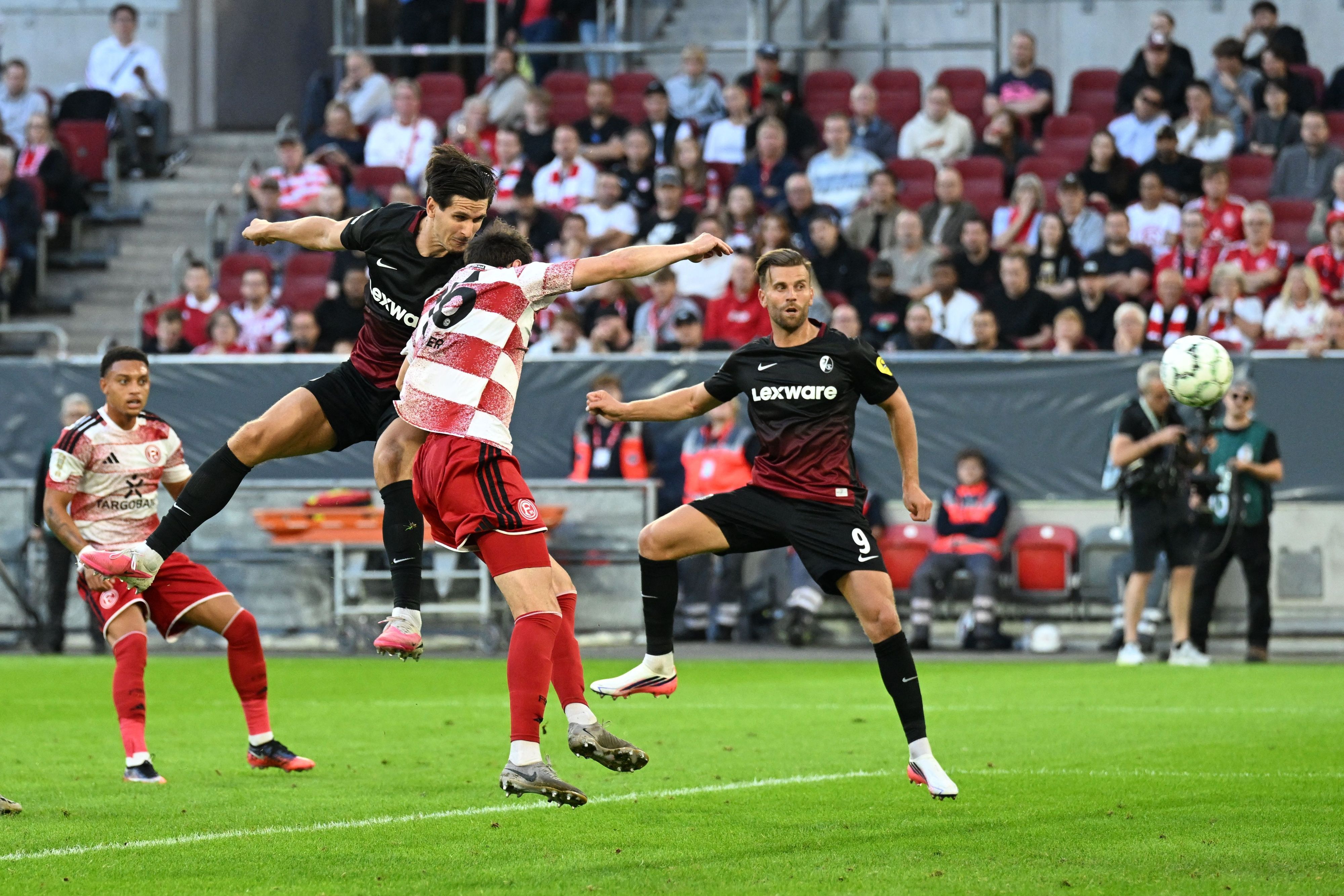 Igor Matanović (oben l, SC Freiburg) erzielt das Tor zum 0:2.