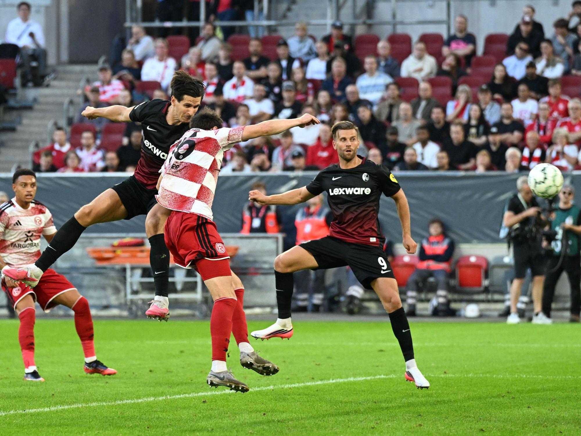 Igor Matanović (oben l, SC Freiburg) erzielt das Tor zum 0:2.