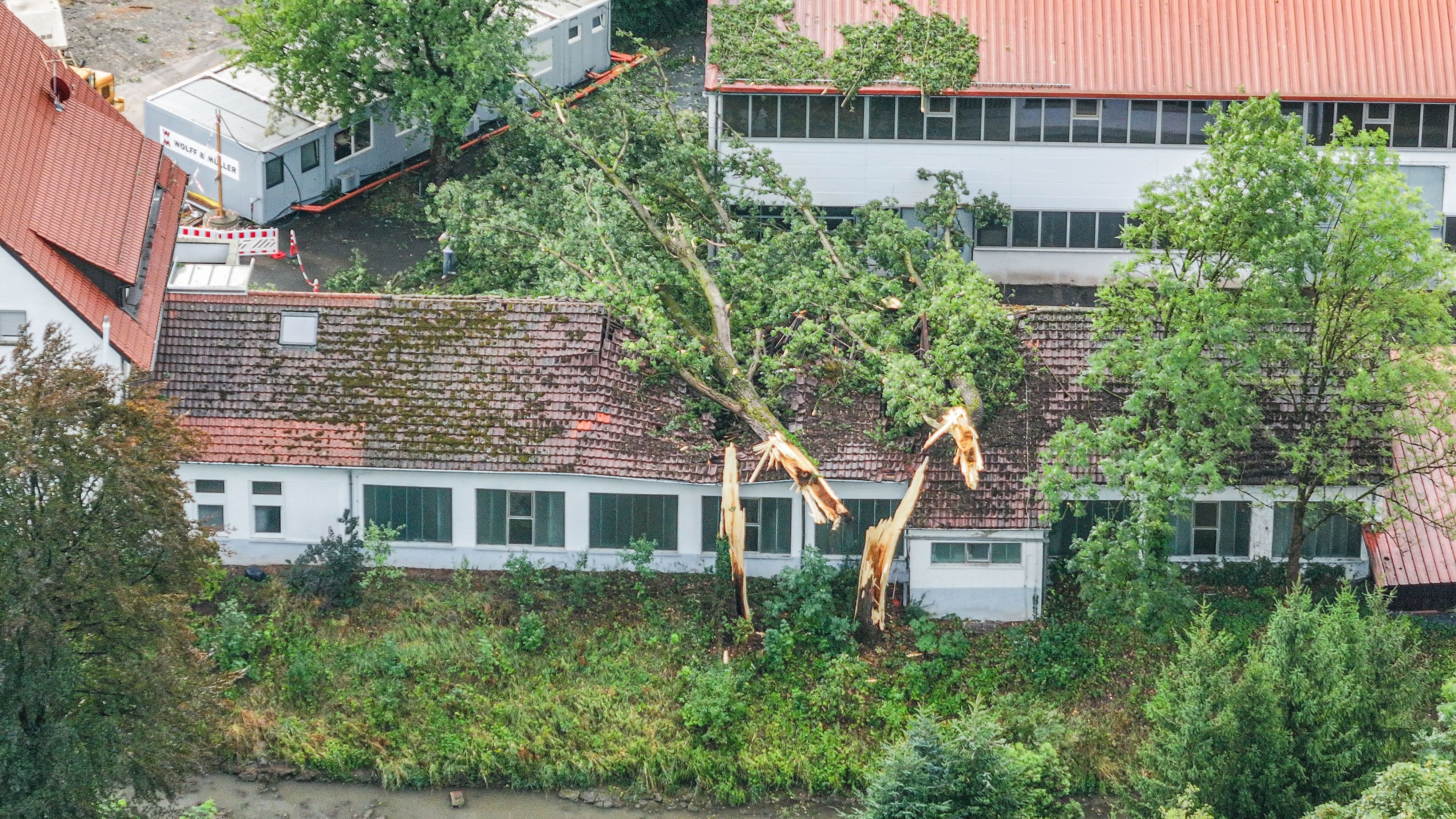 Umgestürzte Bäume auf Gebäude nach Unwetter