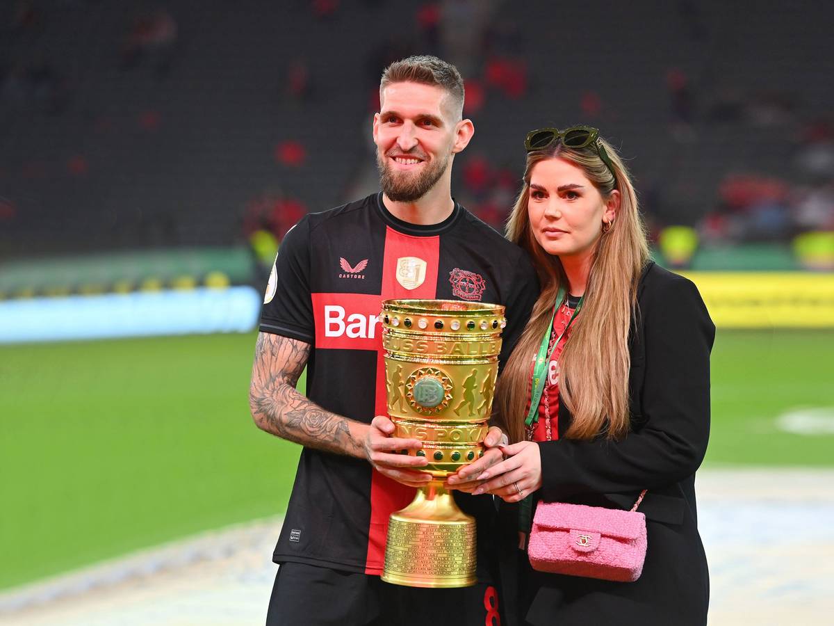 Robert Andrich und Ehefrau Alicia posieren mit dem DFB-Pokal.