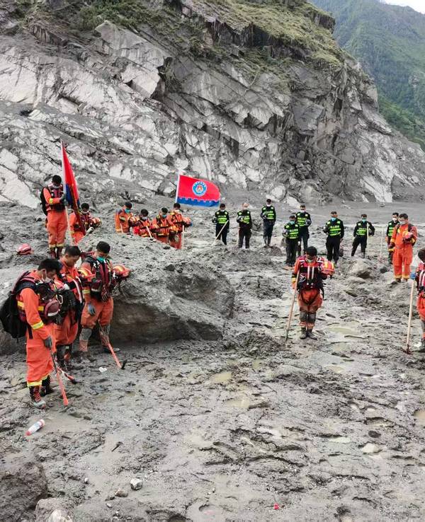 Rettungskräfte legen eine Schweigeminute für die Opfer des Schlammlawinenunglücks vom 26. August in der Nähe des Hafens von Gyirong im Kreis Gyirong in der Autonomen Region Xizang im Südwesten Chinas ein.
