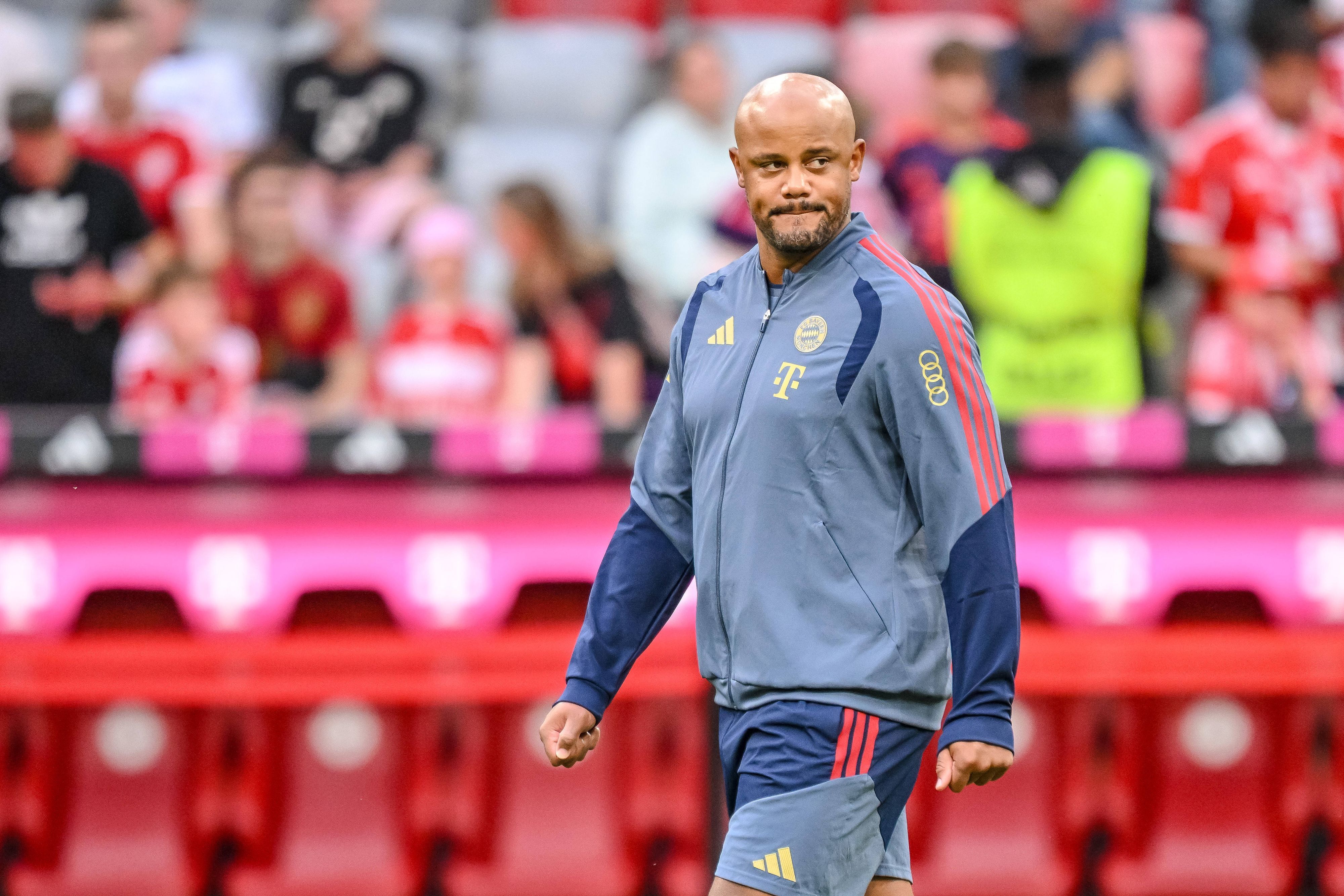 Vincent Kompany in Trainingsjacke mit Sponsorenlogos.