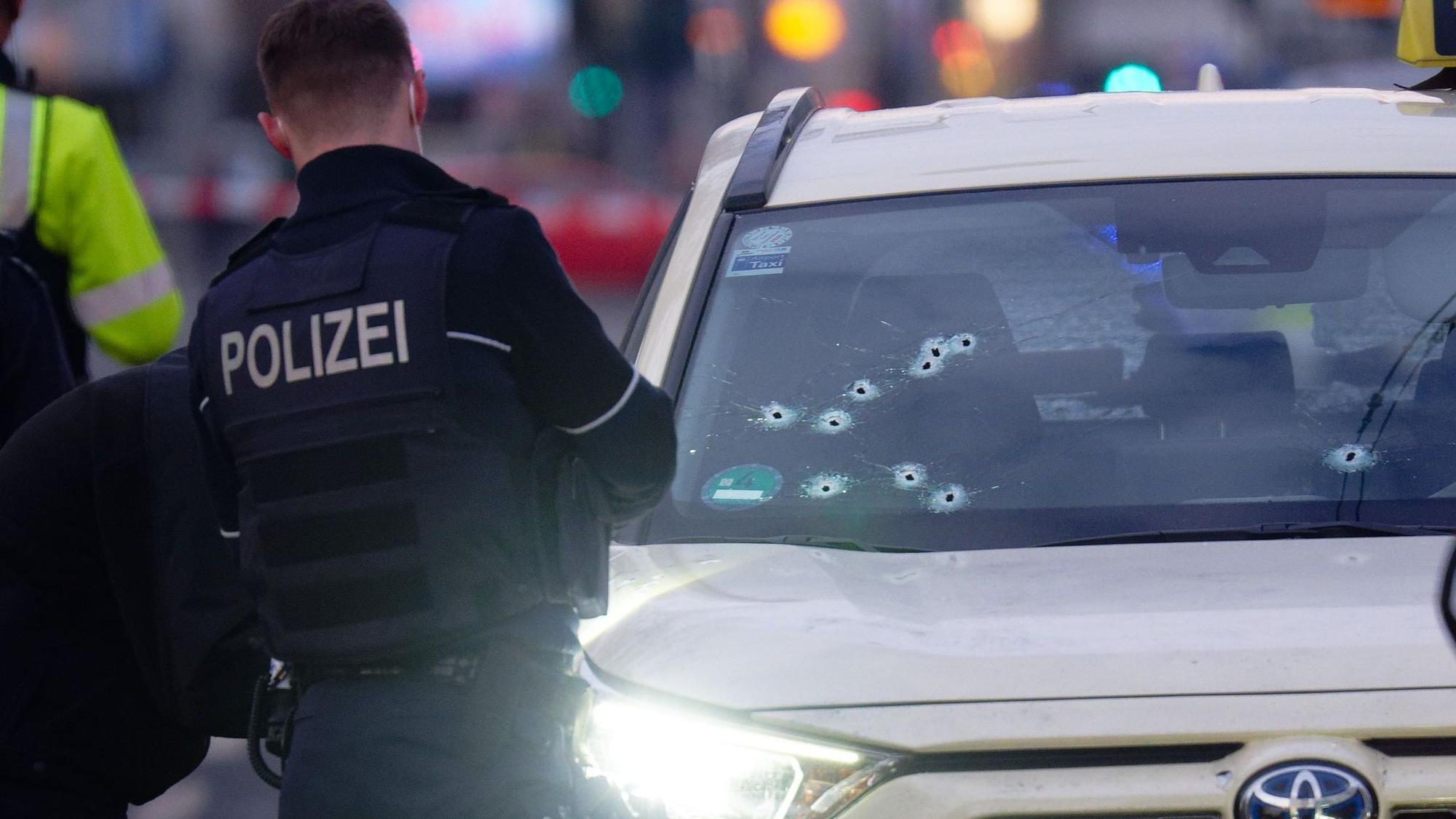 In der Frontscheibe eines Taxis sind mehrere Einschusslöcher.