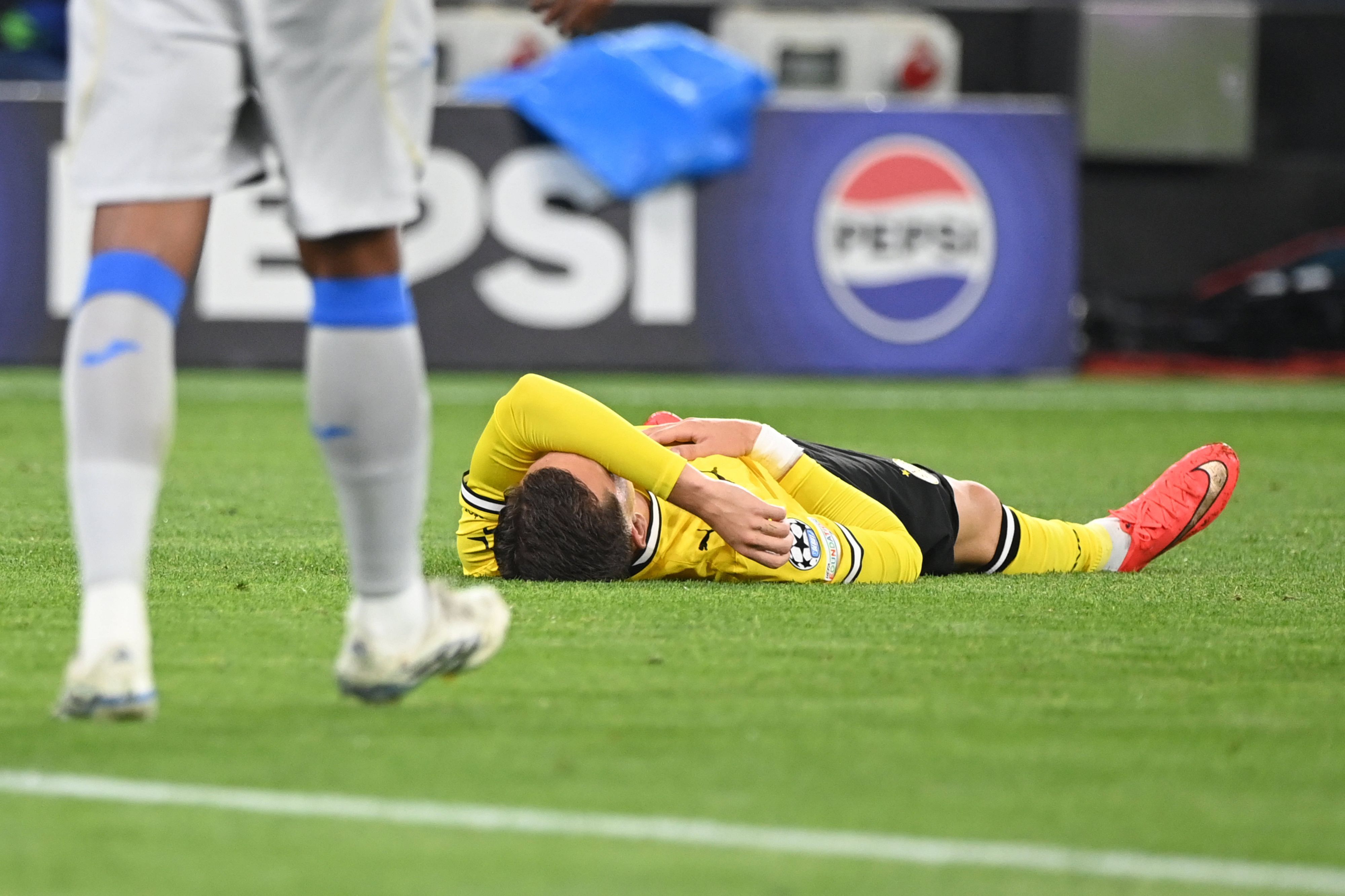 Konstantinos Karetsas liegt am Boden mit dem Arm über seinem Gesicht.