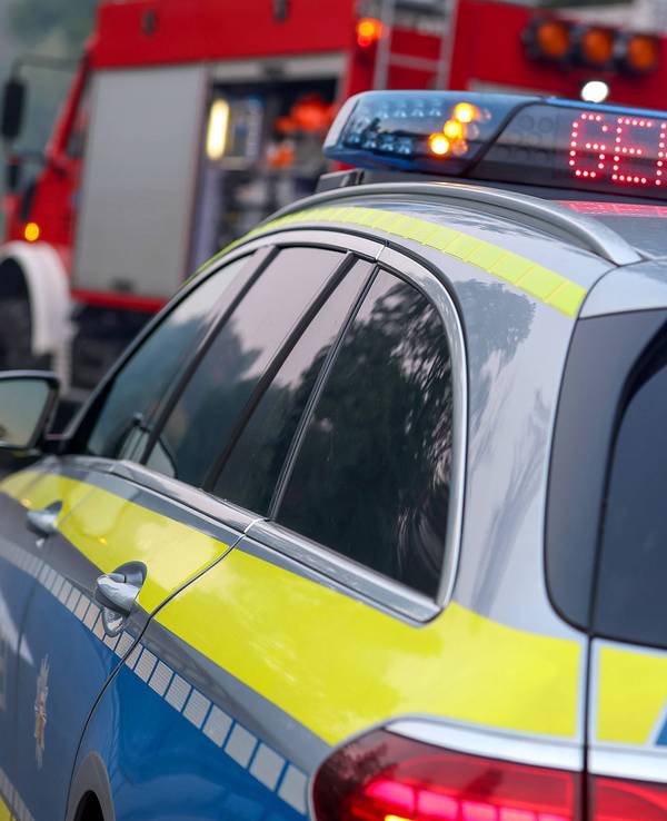 Polizeiauto und Feuerwehrauto mit Blaulicht, Aufschrift Gefahr