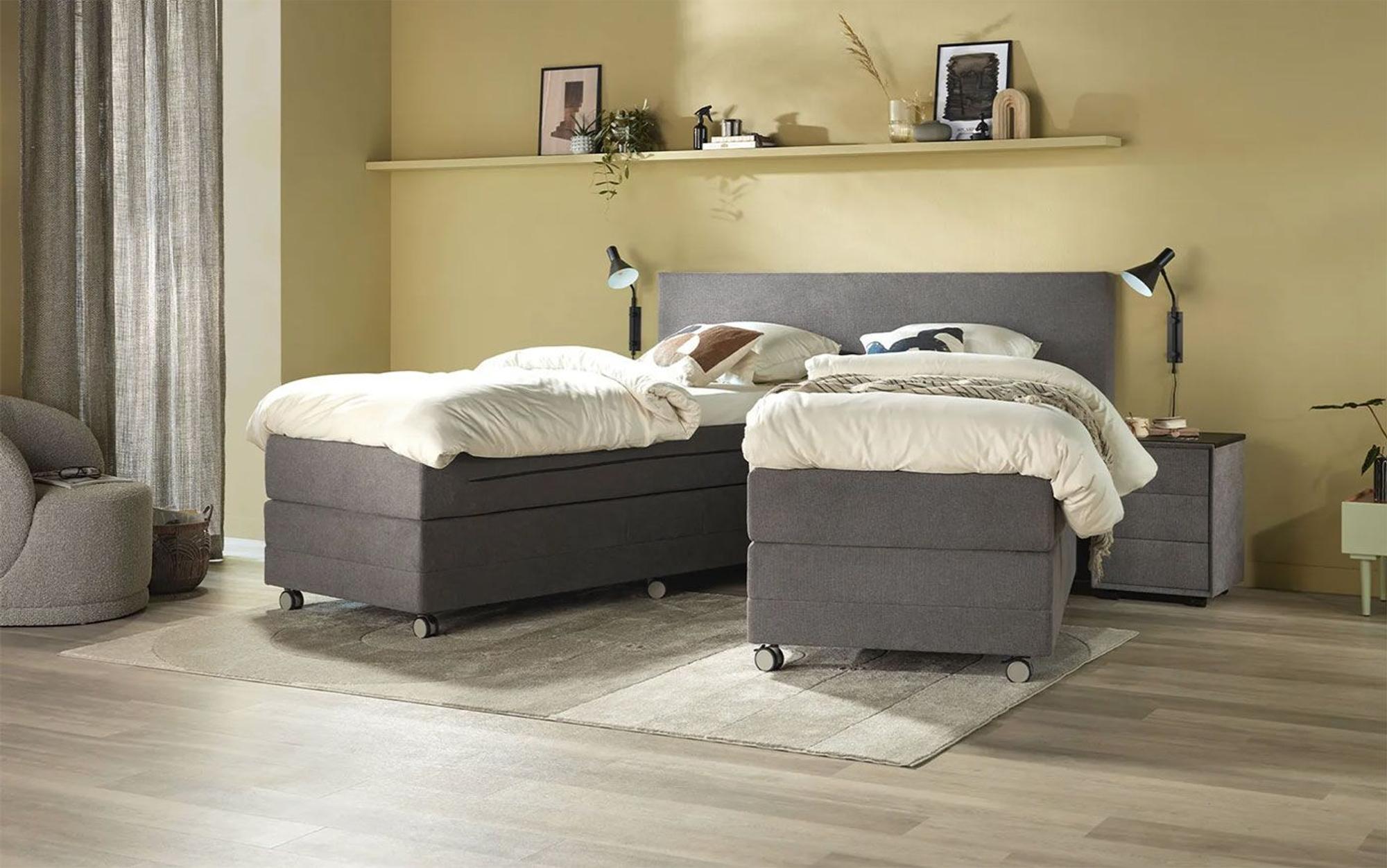 Teilbares Boxspringbett Home 406 Split von Swiss Sense mit Rollen in einem modernen Schlafzimmer.