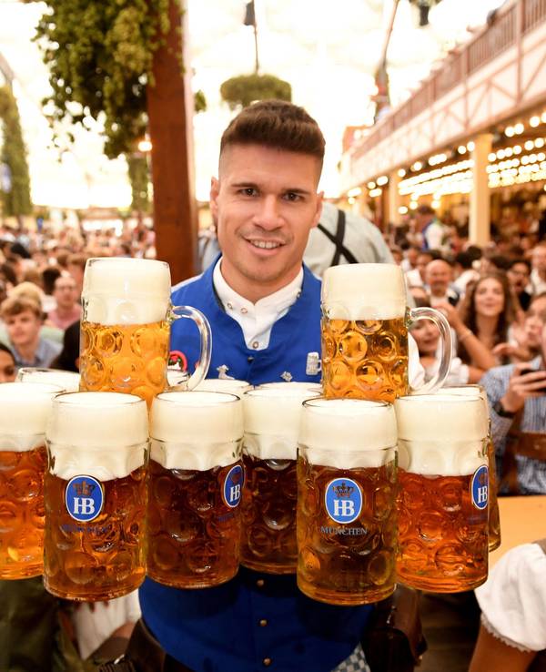 Eine Bedienung bring im Hofbräuzelt nach dem Anstich Bier zu den Gästen