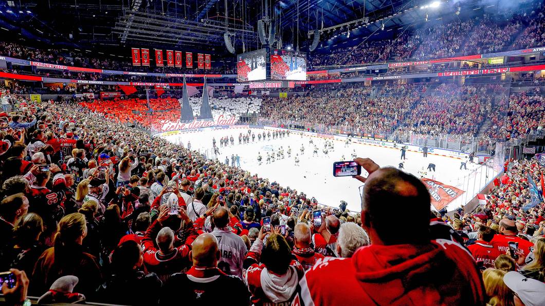 Ein Weitwinkel-Bild aus der vollen Lanxess-Arena, während die Haie-Fans auf der Südtribüne eine rot-weiße Dom-Choreografie zeigen.