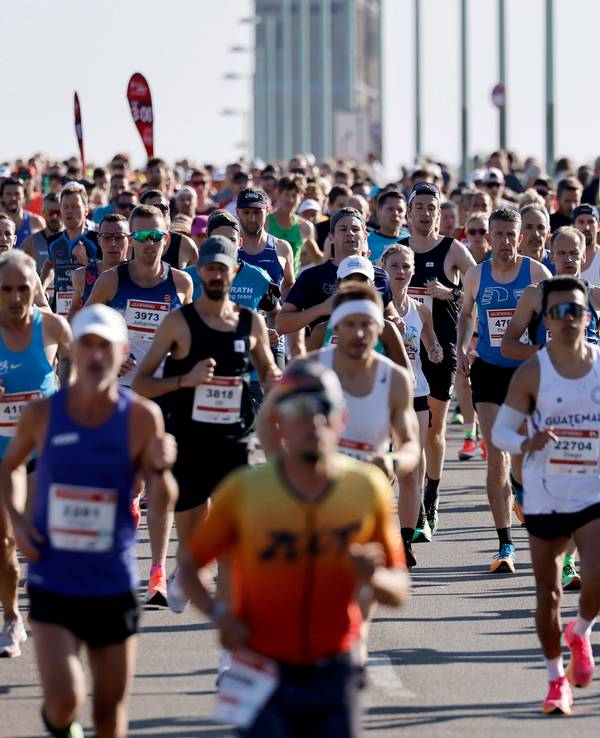 Zahlreiche Teilnehmer des „Generali Köln Marathon“ laufen über die Deutzer Brücke.