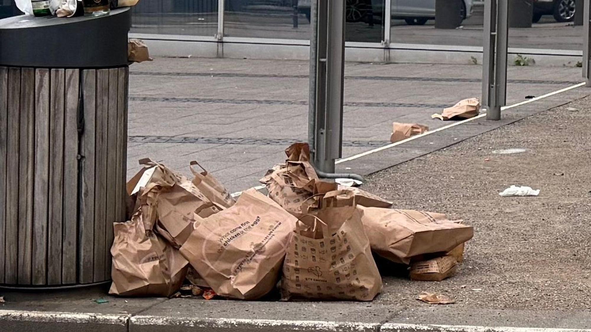 Jede Menge Nhas-Tüten liegen neben dem Mülleimer auf dem „Maus“-Platz.